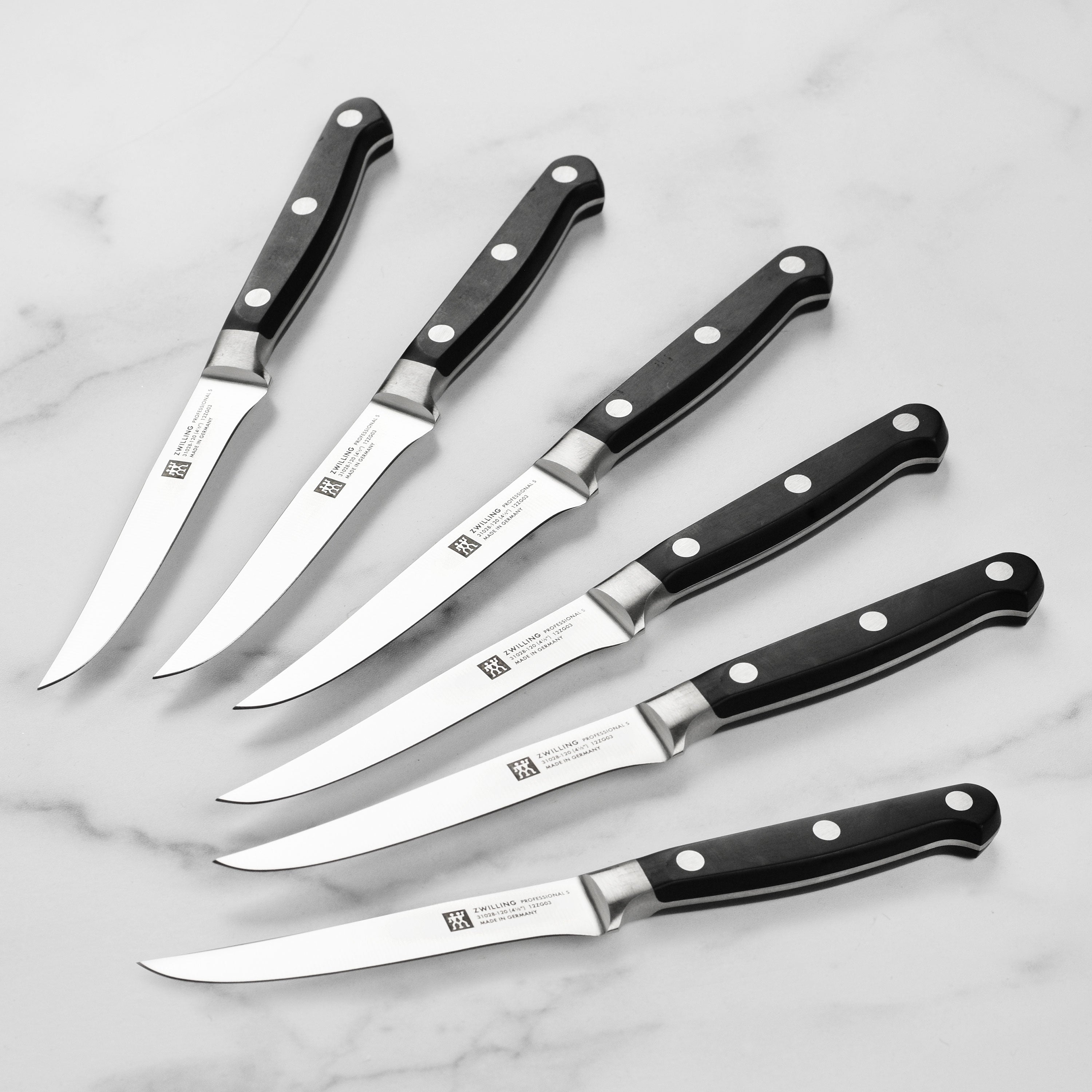 Precision Cut Professional Steak Knife Set showcasing sharp blades and ergonomic handles.