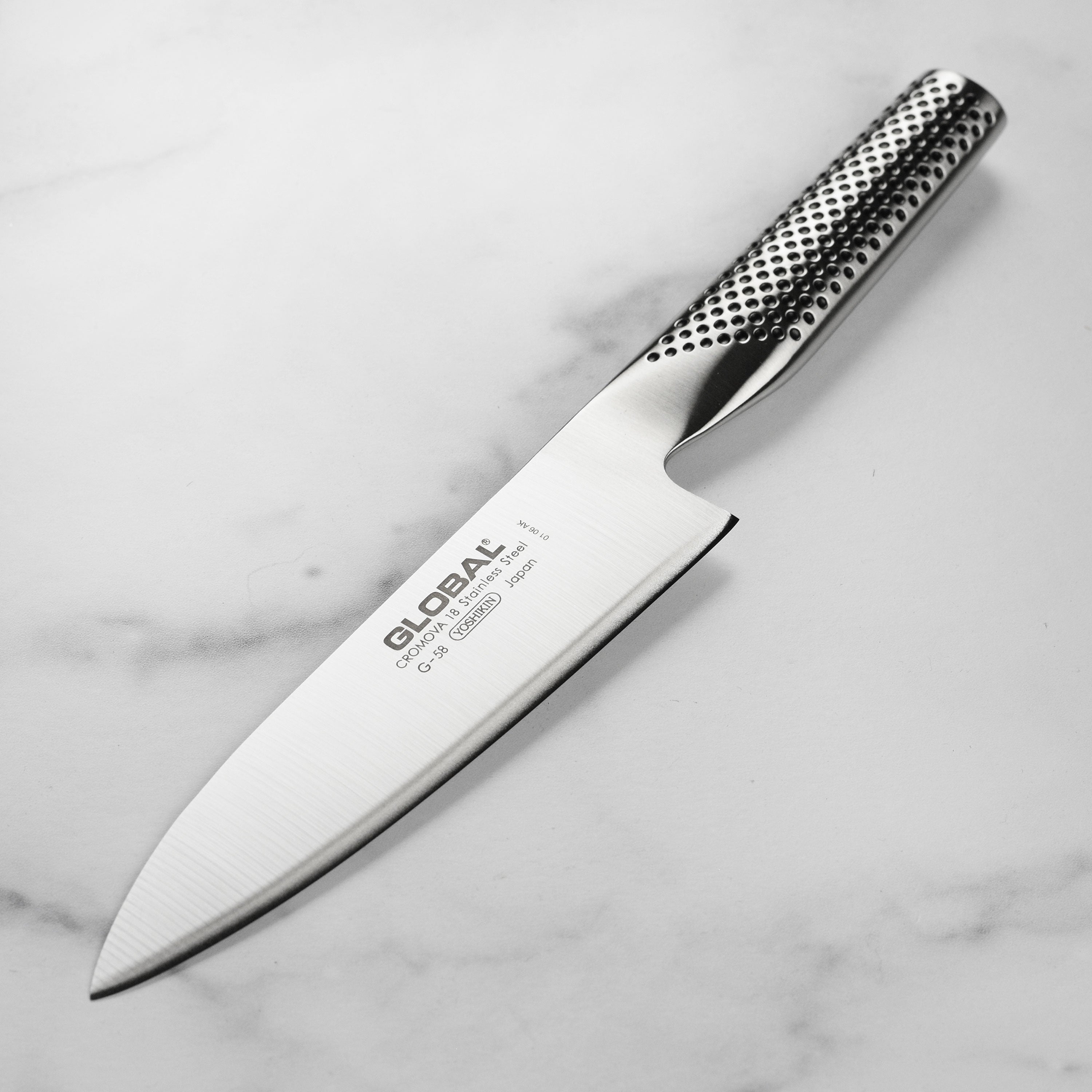 Global 6-inch chef's knife with sharp blade and ergonomic handle for precision slicing