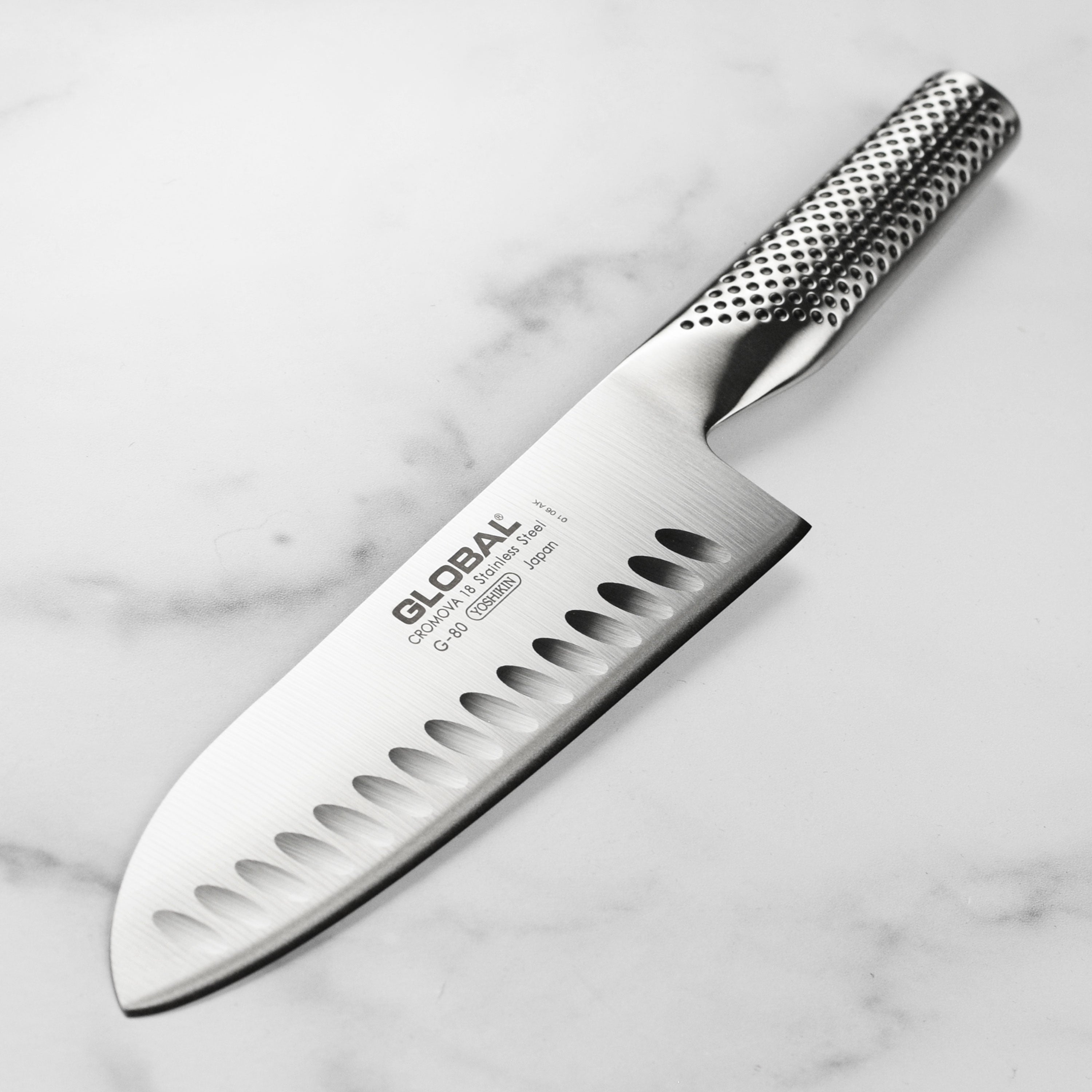 Global 7-inch hollow edge Santoku knife with detailed blade and handle view