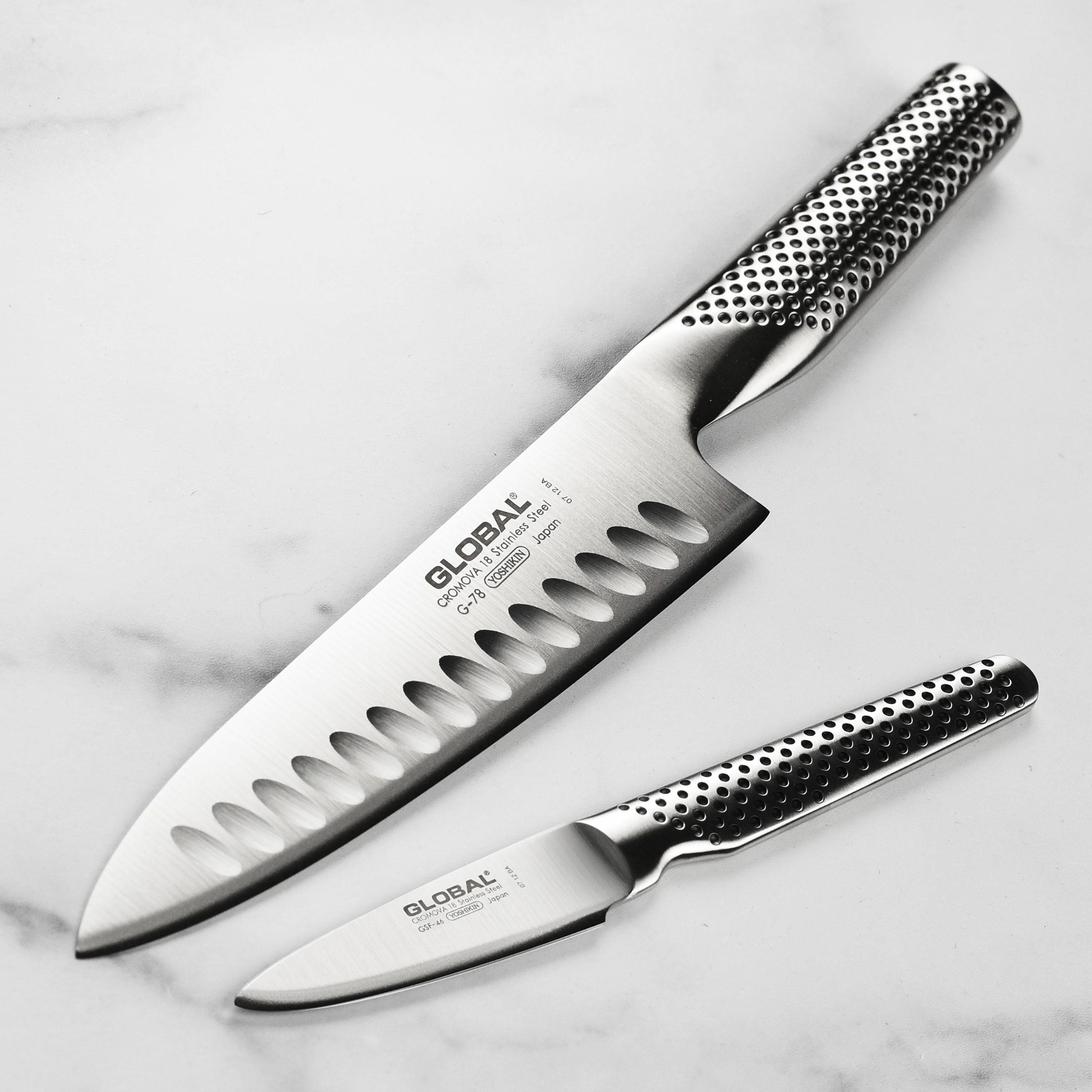 Close-up of hollow edge chef's knife blade showing razor-sharp edge and smooth finish