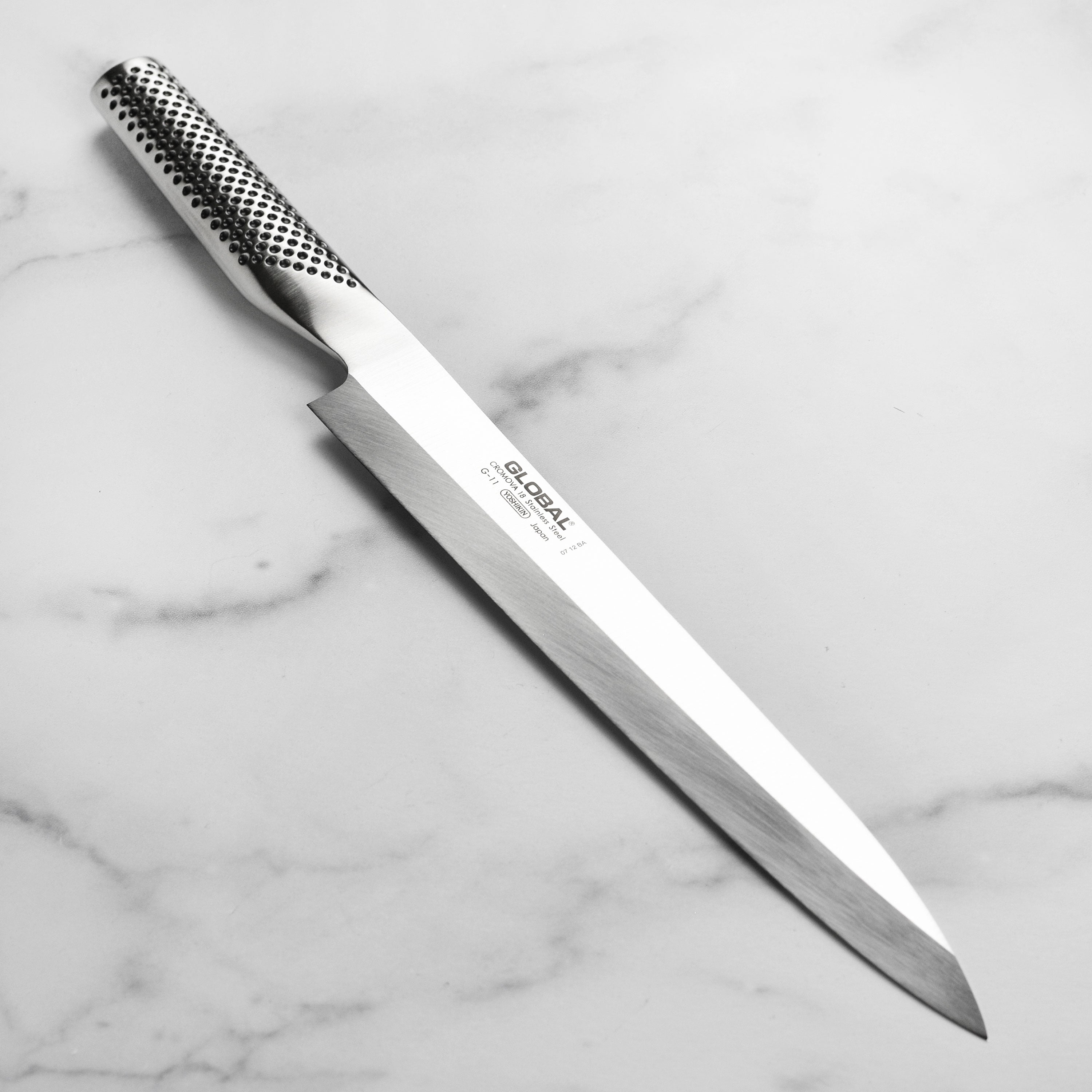 Premium Japanese sashimi knife showcasing the single bevel edge for precise slicing.