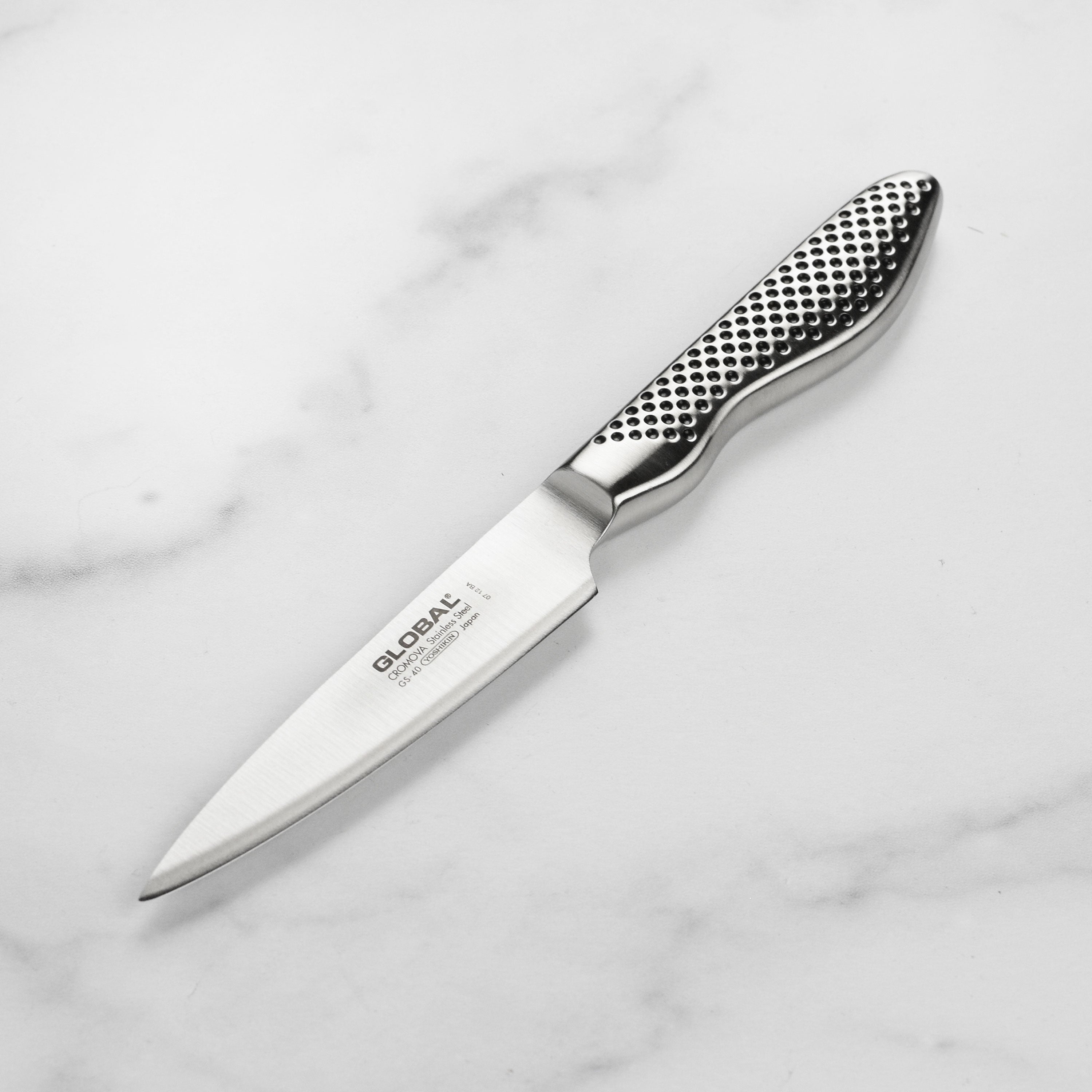 Close-up of the 4-inch Japanese paring knife highlighting the razor-sharp stainless steel blade.