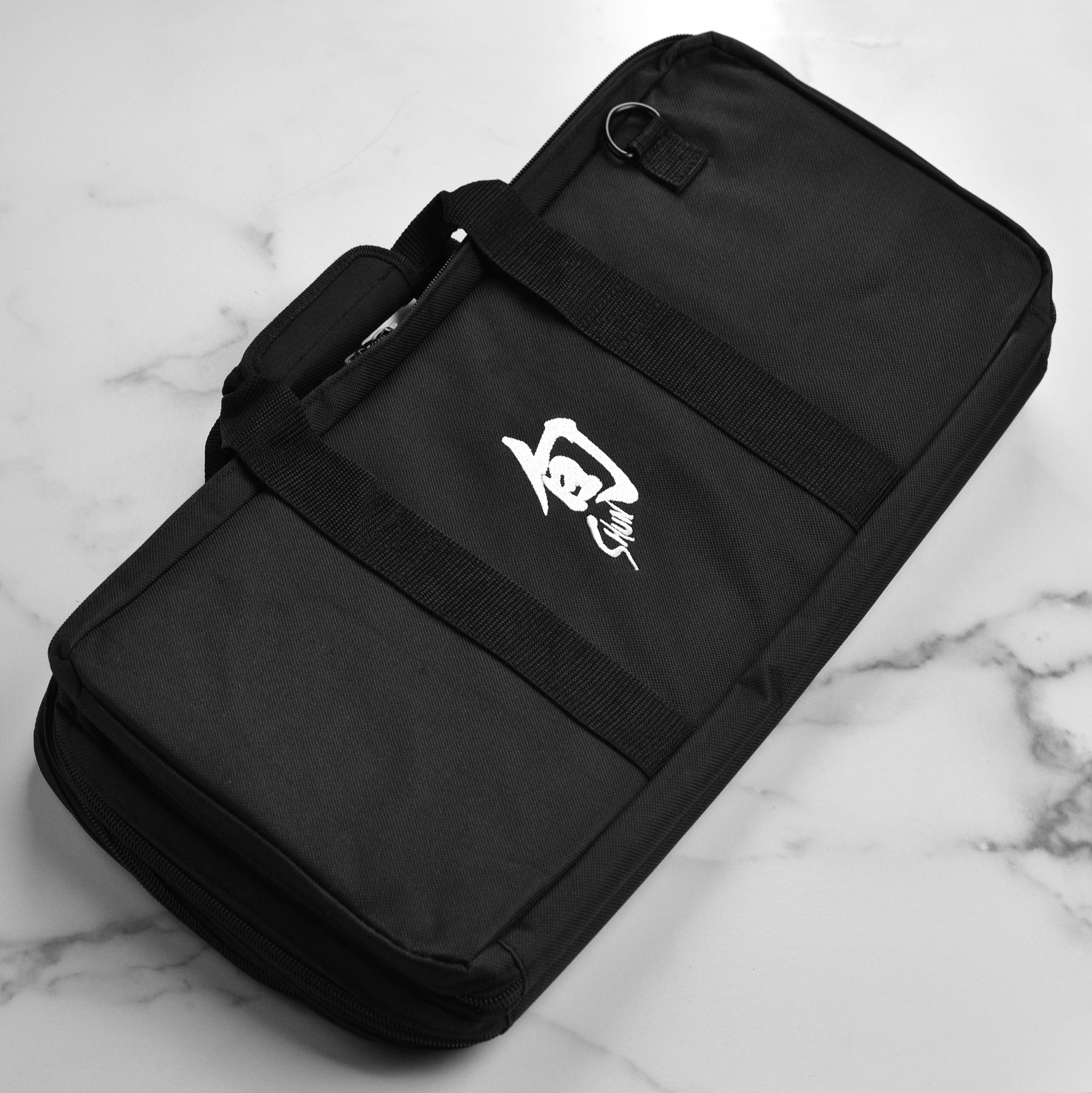 Premium 20-pocket knife travel case displaying its padded handle and durable material
