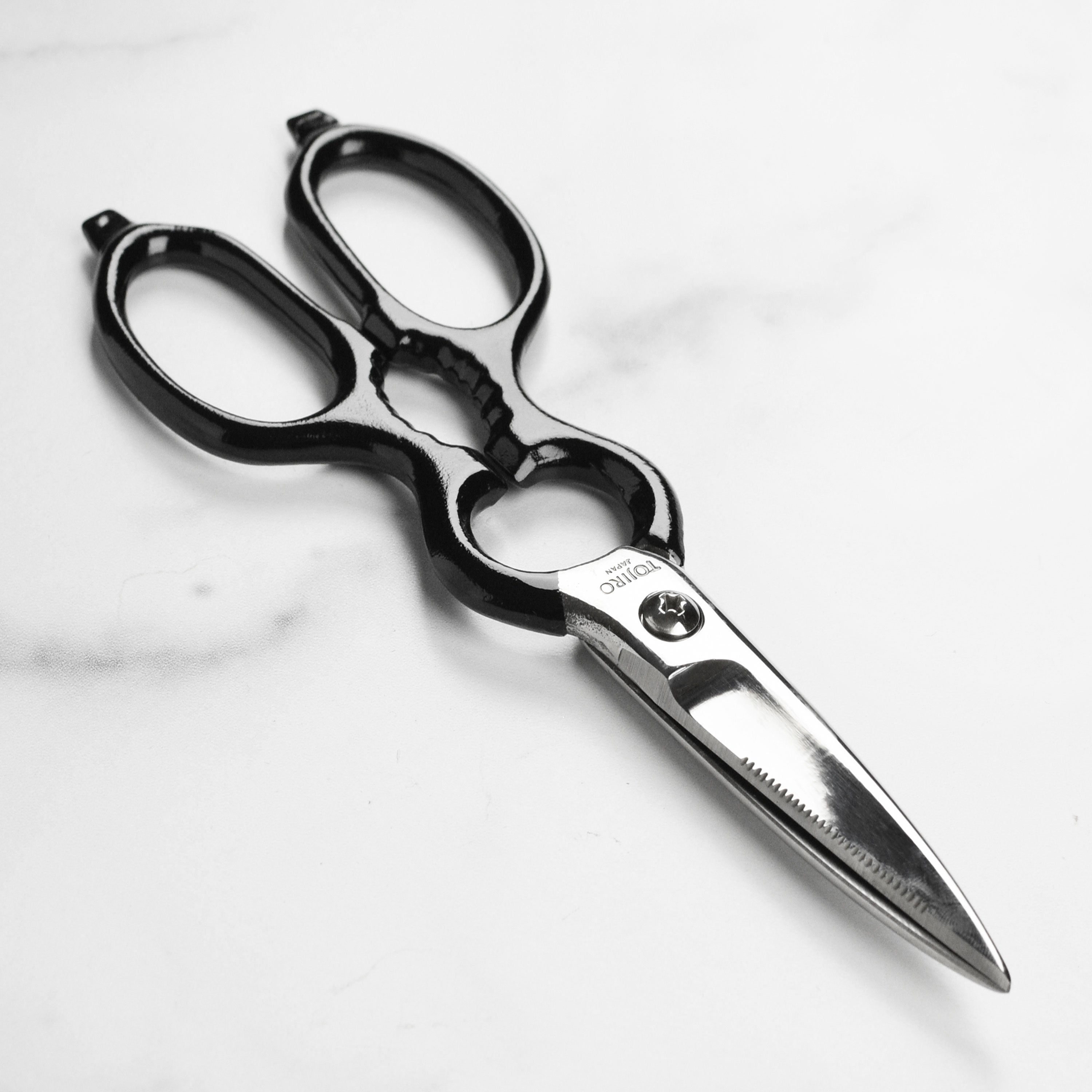 Tojiro forged kitchen shears with bottle opener on black handle, ideal for cutting meat and opening bottles