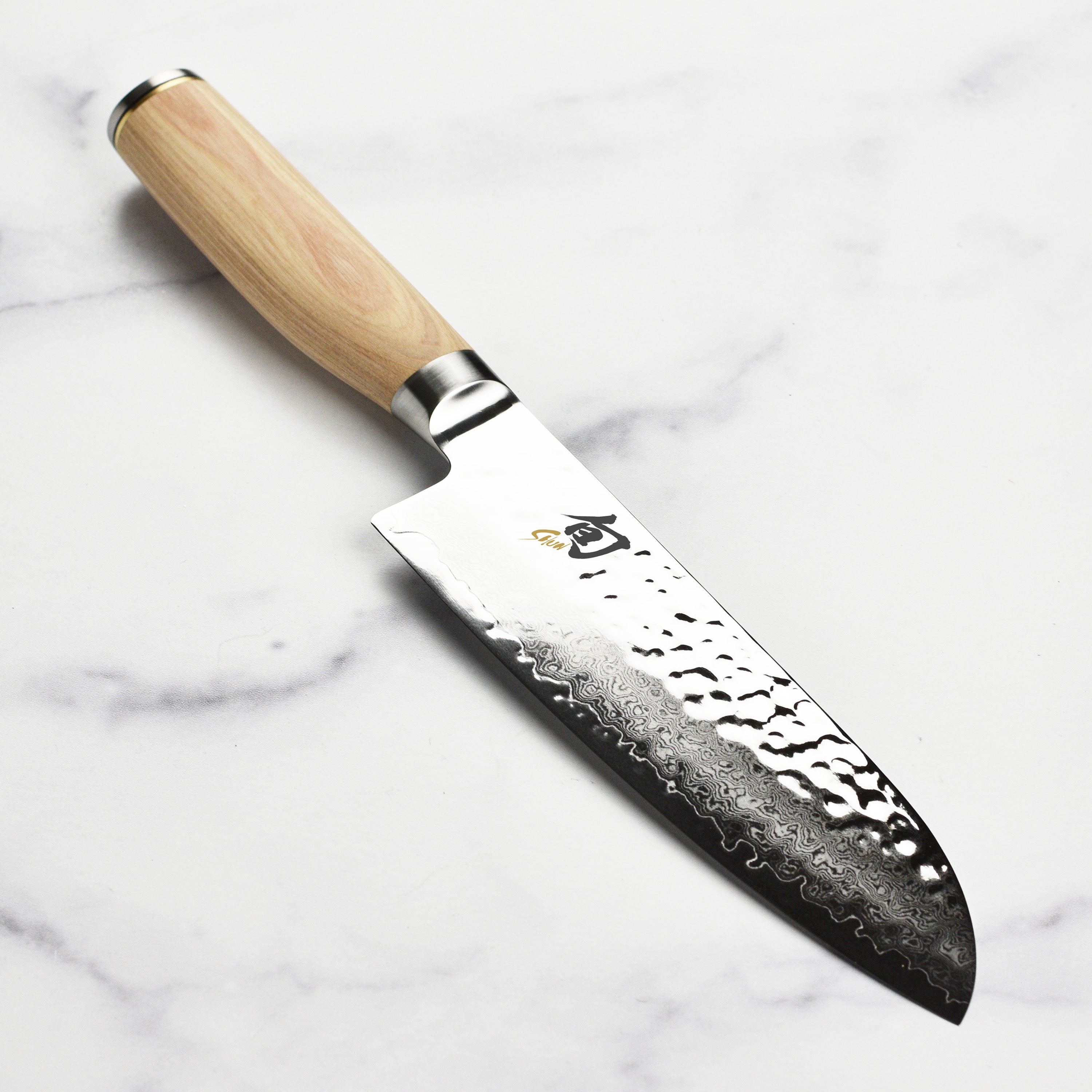 Close-up of the handcrafted Japanese Santoku knife blade showing Damascus layers