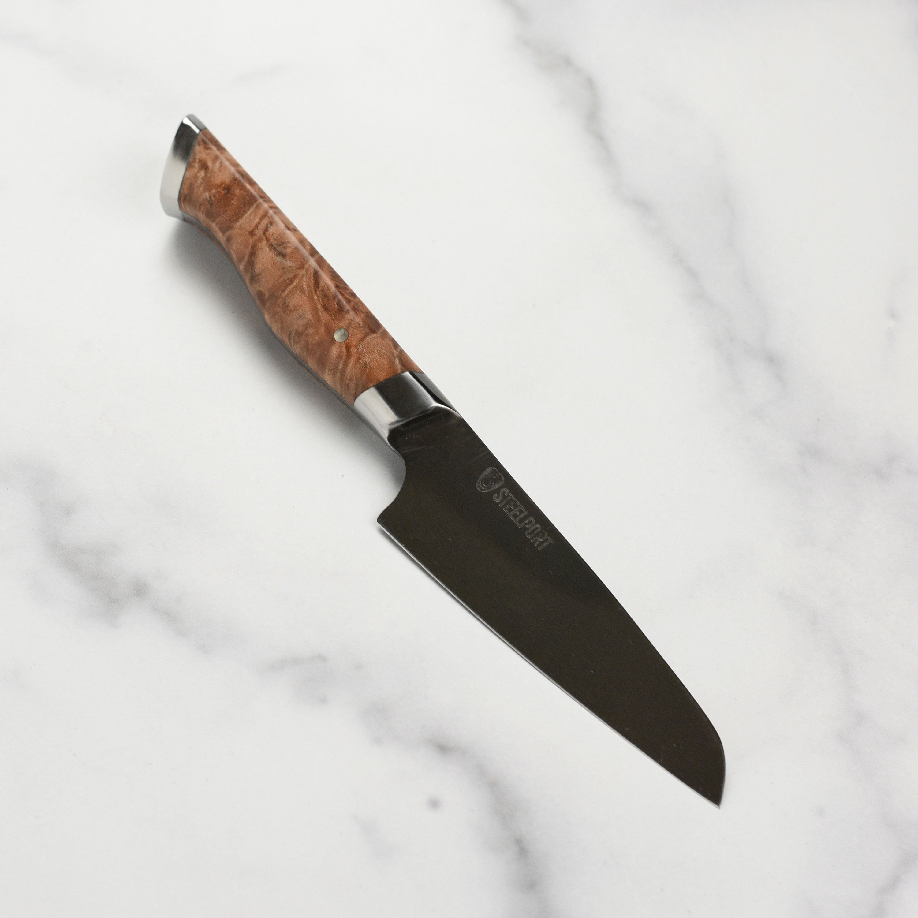 Steelport 4-inch carbon steel paring knife highlighting the blade's sharp edge and full tang construction