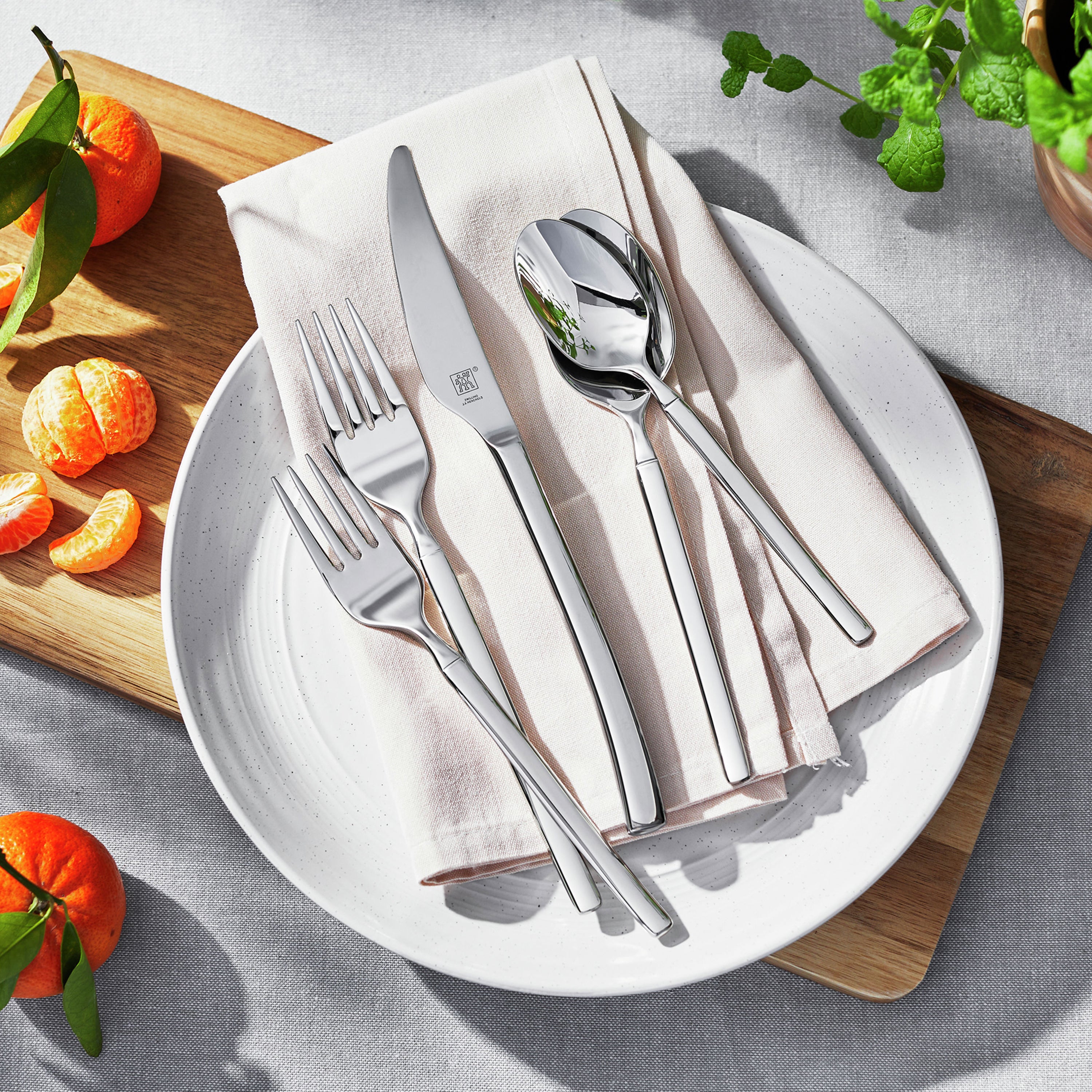Elegant 45-piece stainless steel cutlery set displayed on a dining table, perfect for family gatherings.