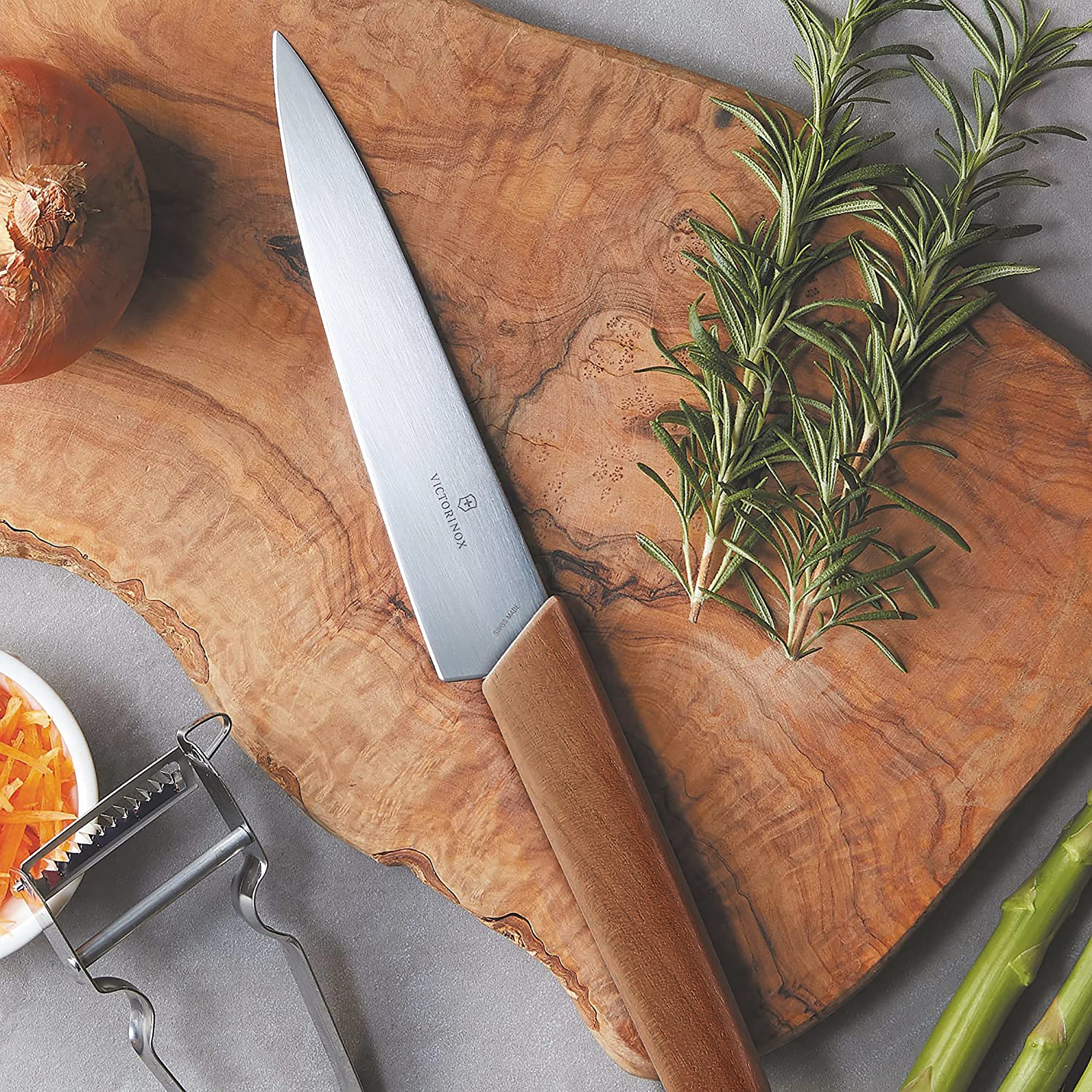 Full view of the Victorinox Swiss Modern knife set arranged on a kitchen counter, featuring the elegant wooden block.