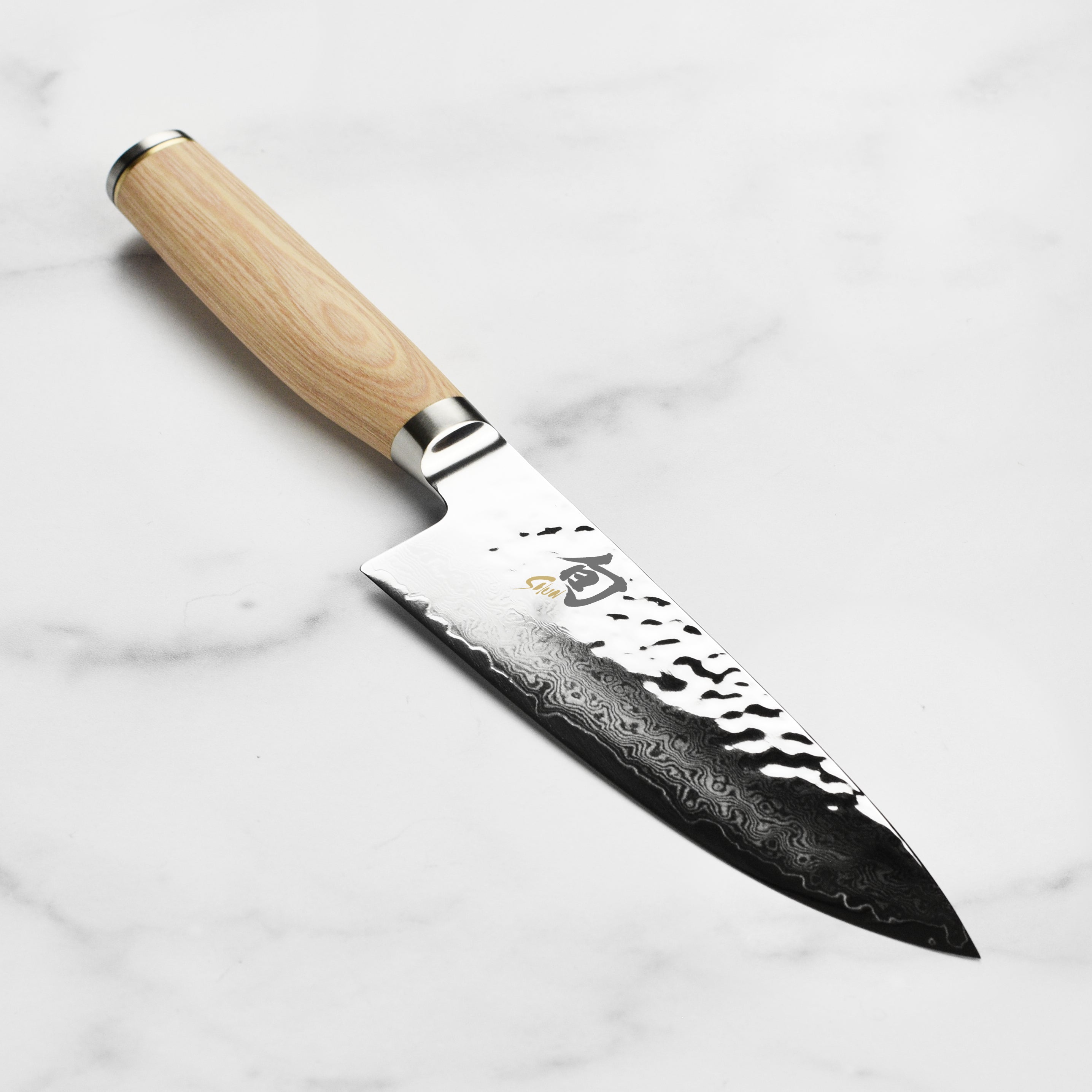 Shun Premier Blonde 6-inch chef's knife showing the beautiful Damascus finish and blade design.