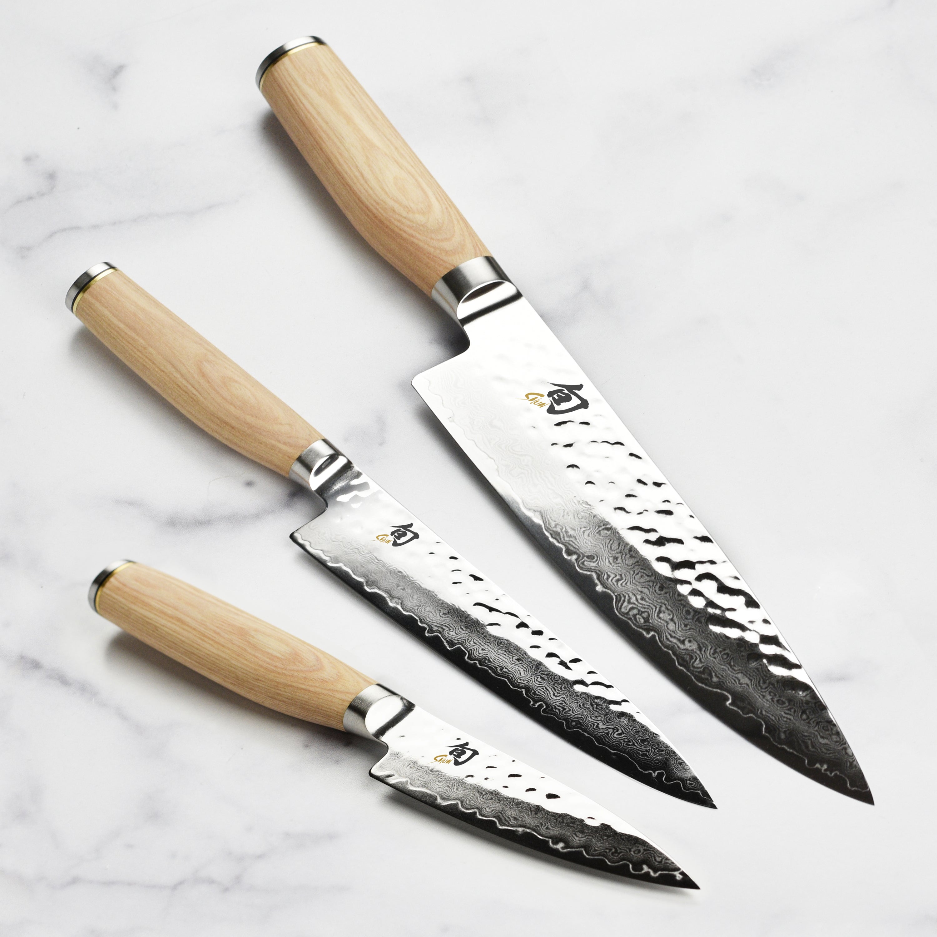 Close-up view of the Shun Premier Blonde knife set highlighting the Damascus steel and PakkaWood handle.