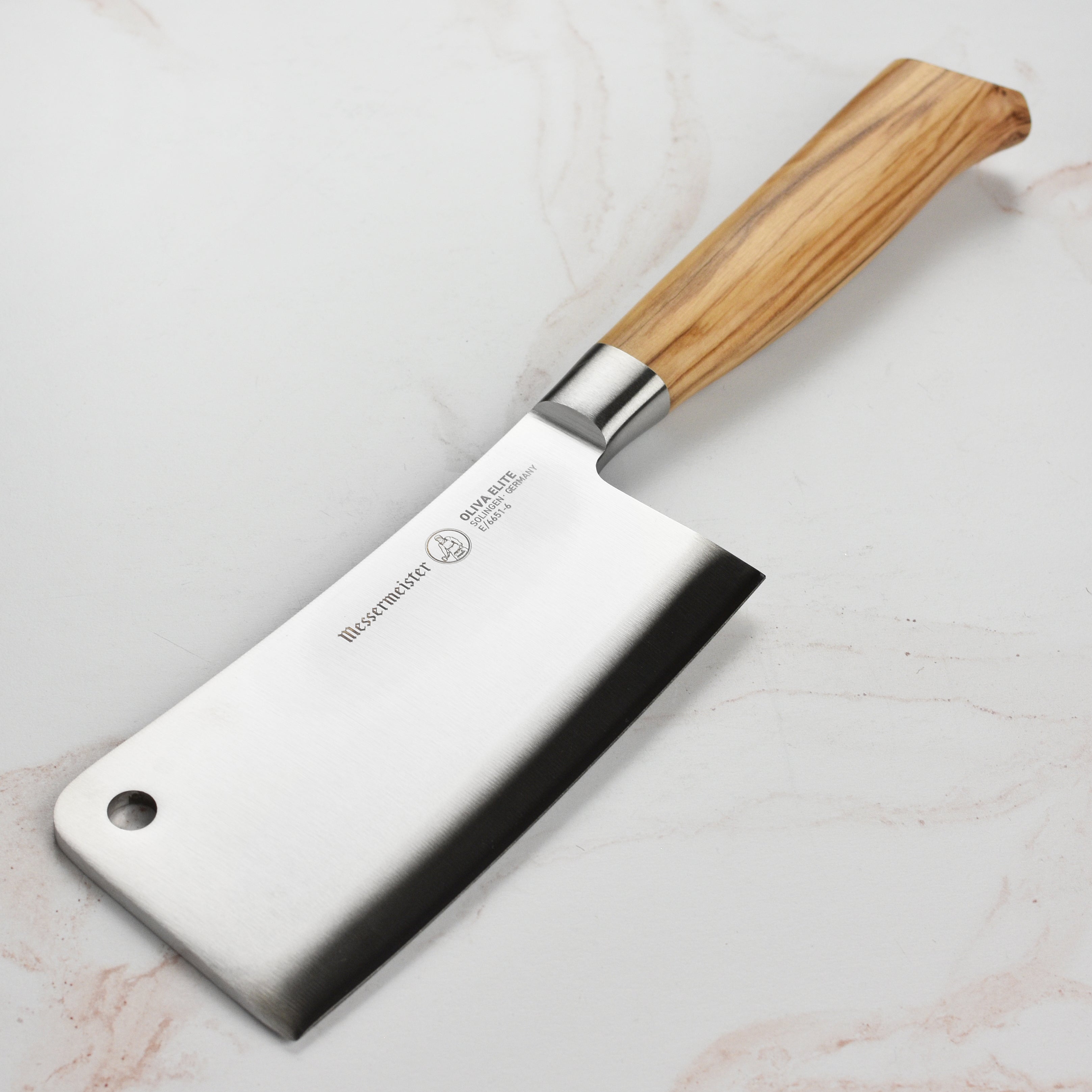 Close-up of the Messermeister Oliva Elite 6-inch meat cleaver with German steel blade and olive wood handle