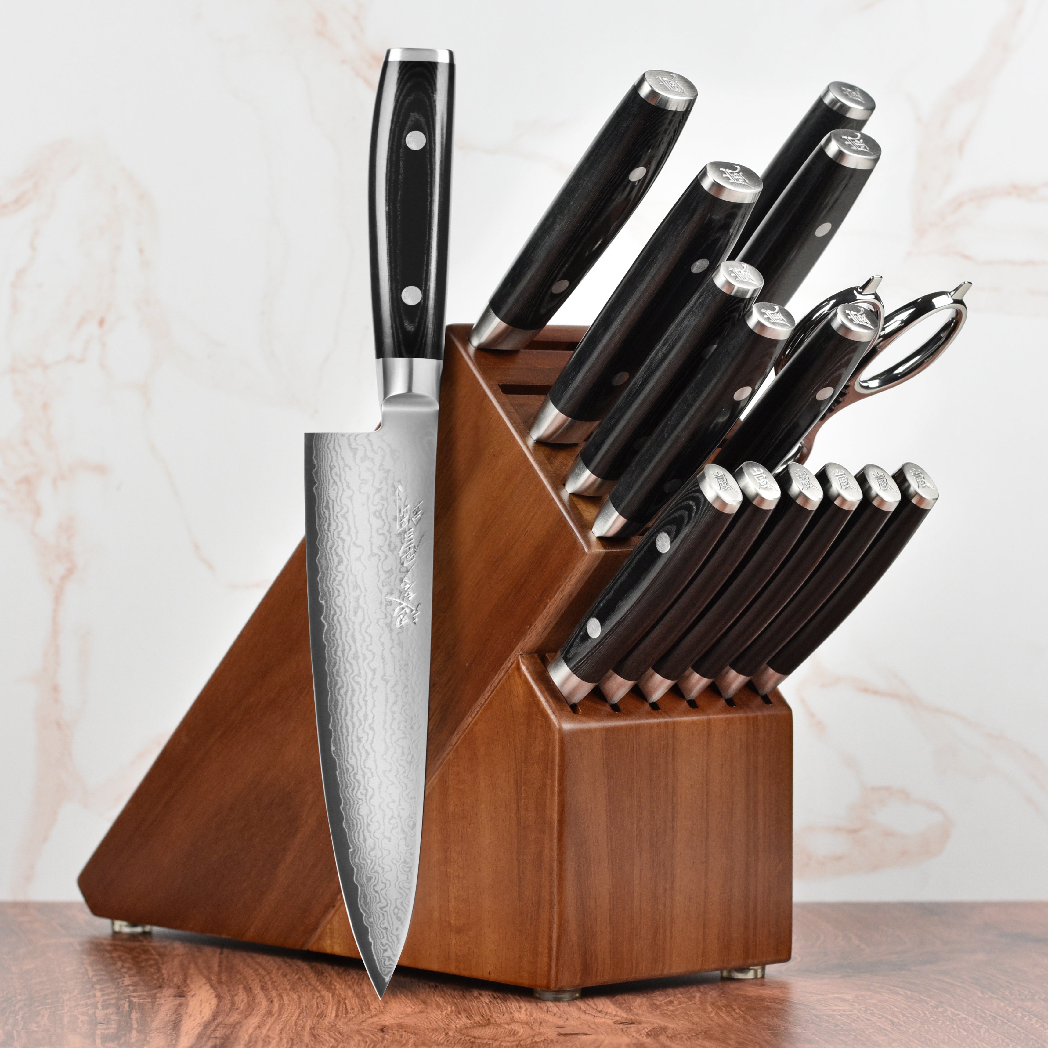 Yaxell Ran Plus knife set showcasing the Damascus pattern and sleek design.