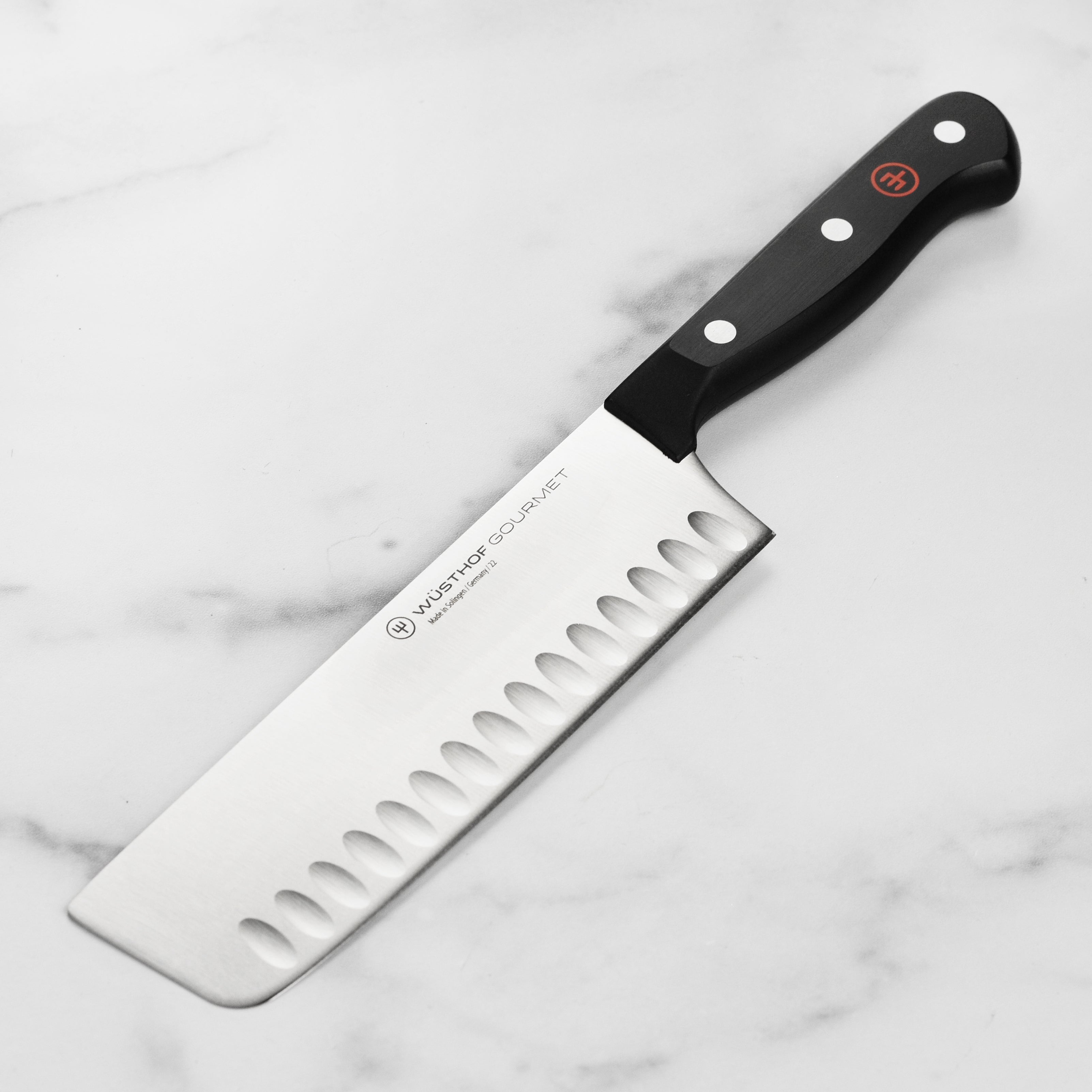 Gourmet Precision Nakiri Knife with high-carbon stainless steel blade and ergonomic handle, perfect for slicing vegetables.