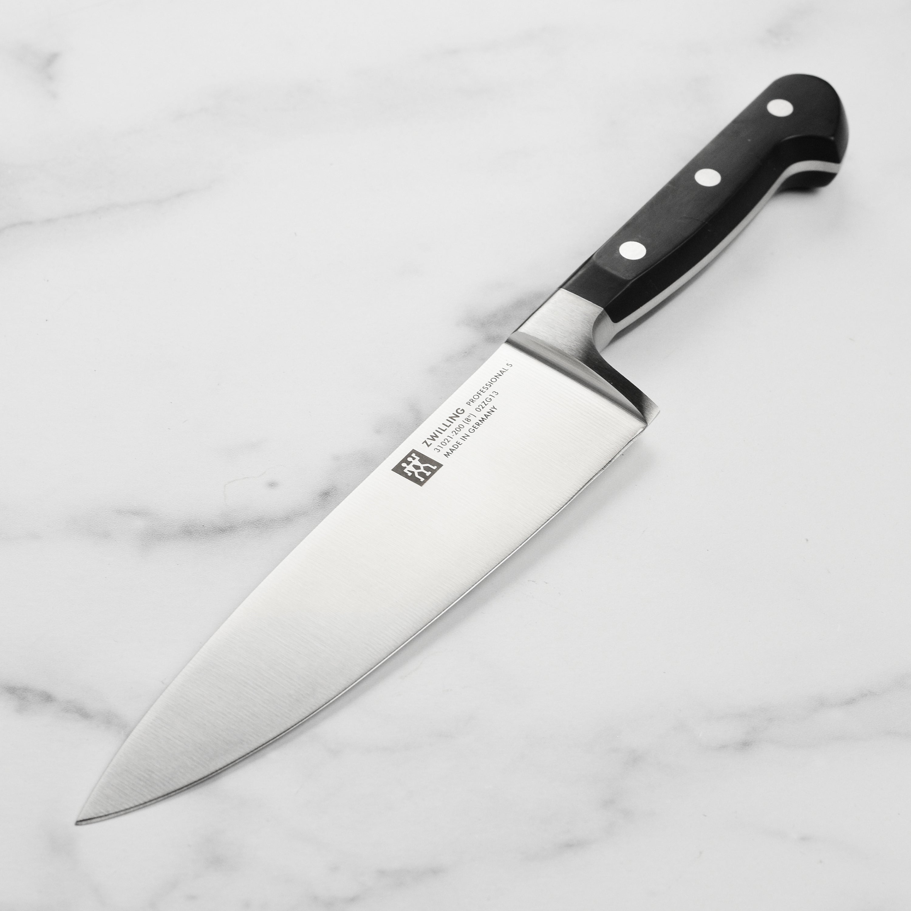 Close-up of Zwilling ProEdge blade showing high carbon steel finish and 15° edge angle
