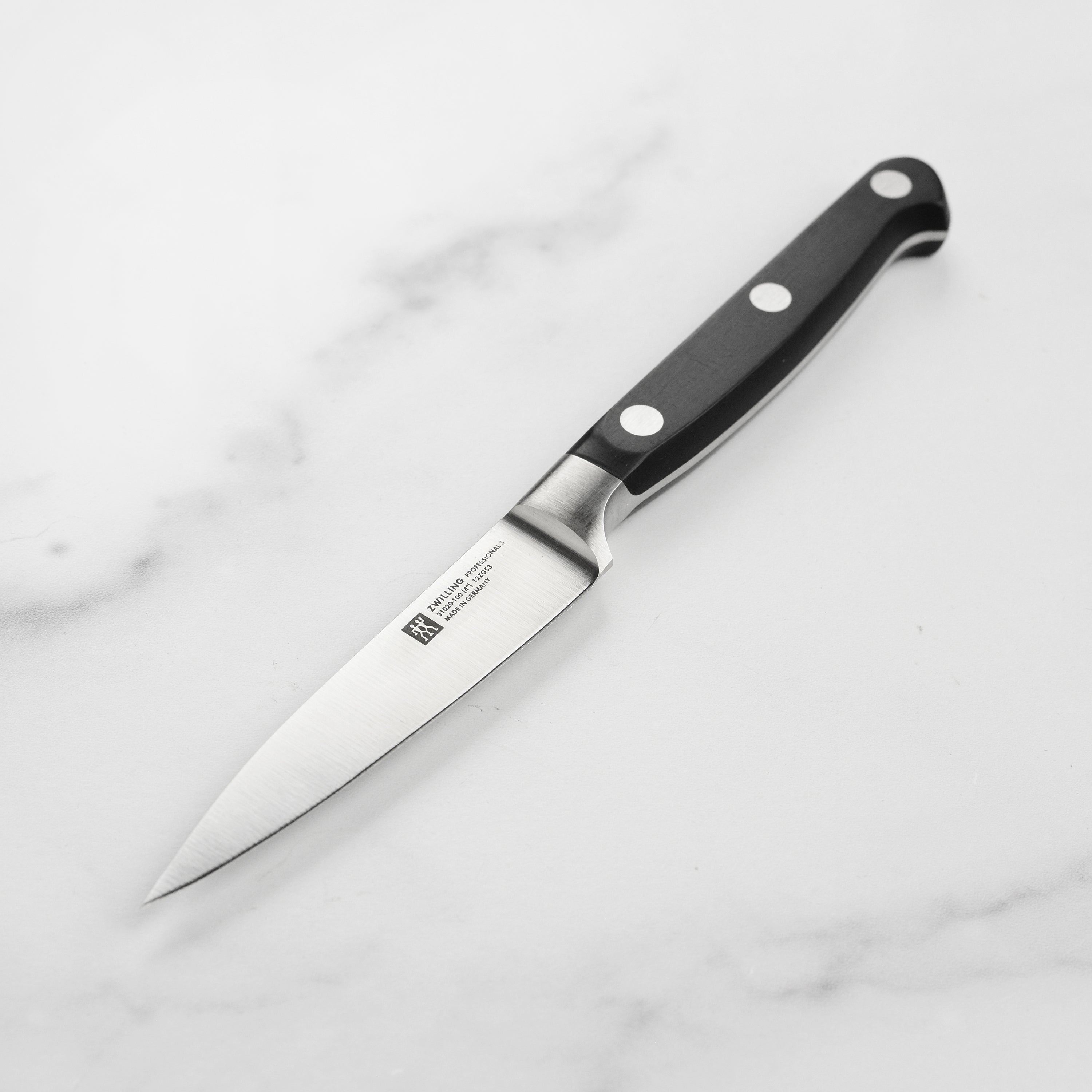 Close-up of the German Precision Paring Knife showcasing its sharp blade and ergonomic handle.