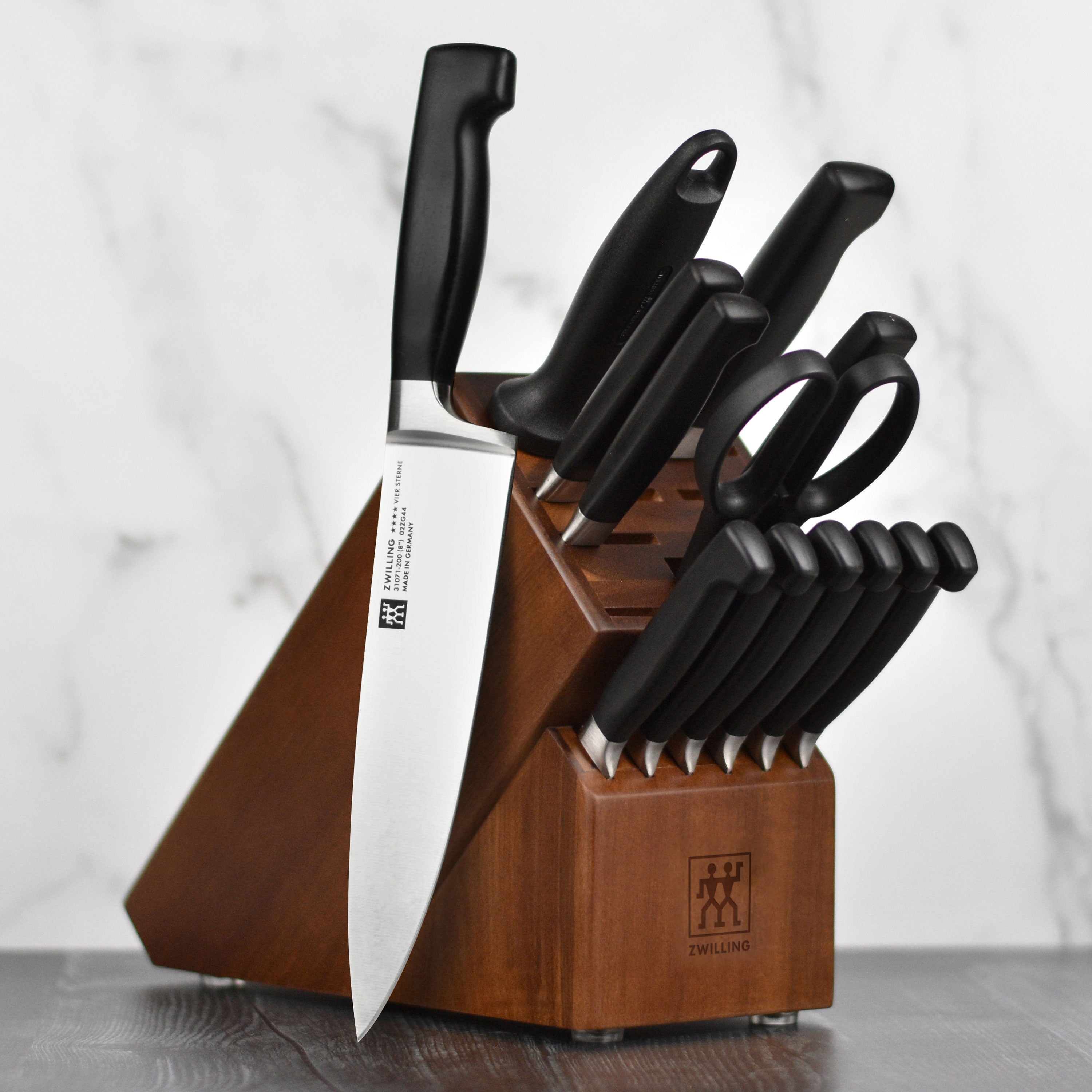 A close-up of the Zwilling Four Star knife block set, highlighting the high carbon steel kitchen knives.