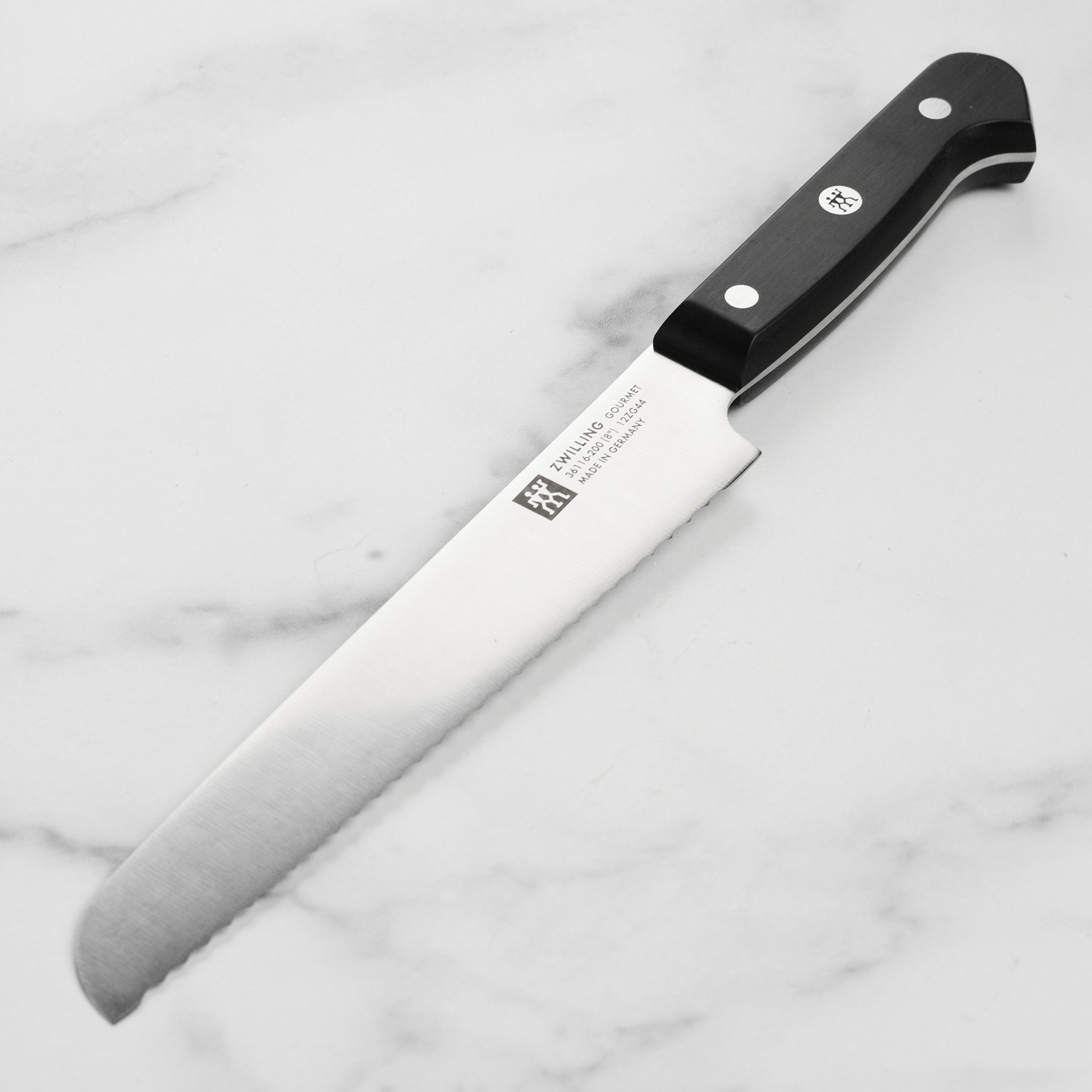 Close-up of the Gourmet Precision 8-Inch Bread Knife blade showing its high-carbon stainless steel edge.