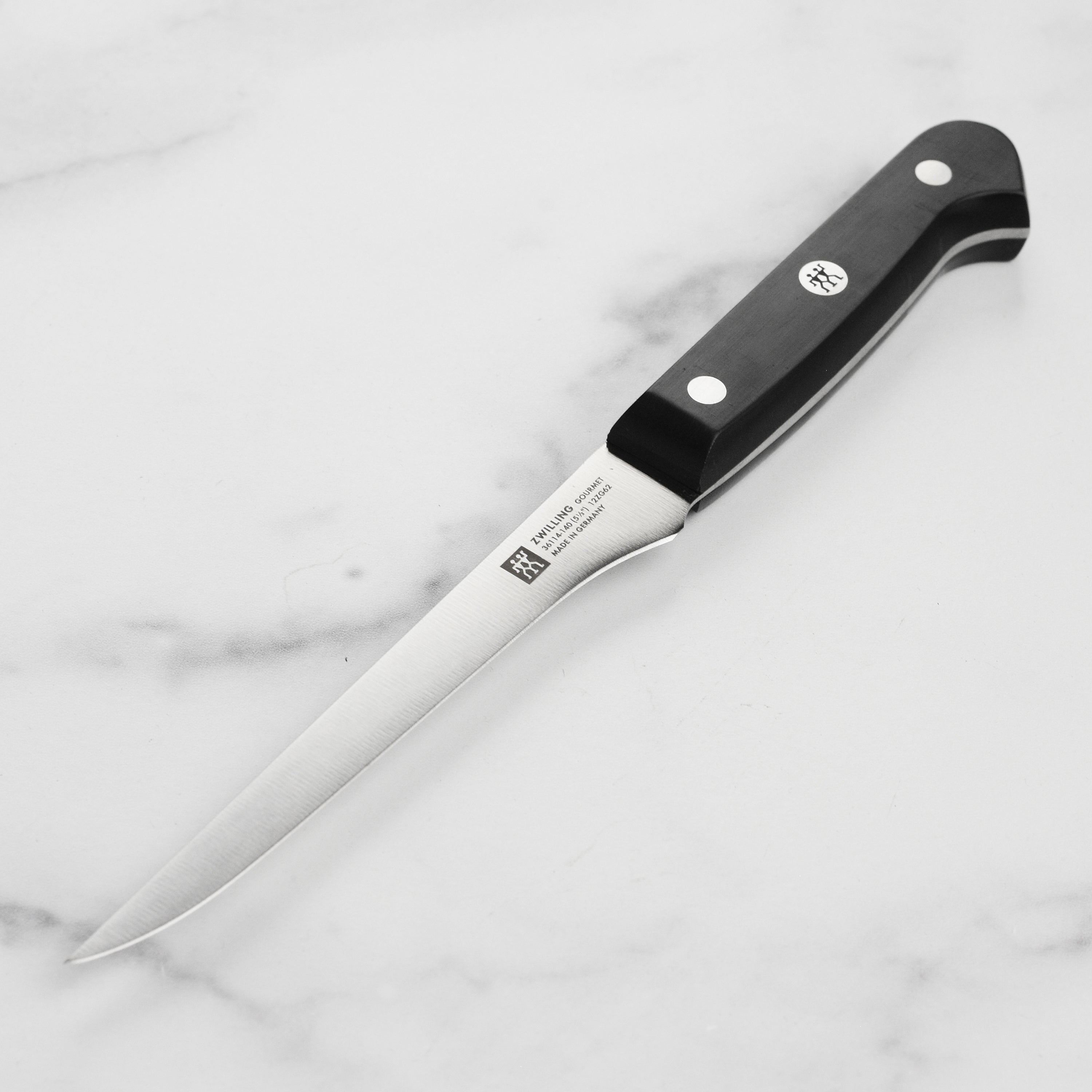 Close-up view of Zwilling Professional boning knife highlighting its sharp blade and ergonomic handle.