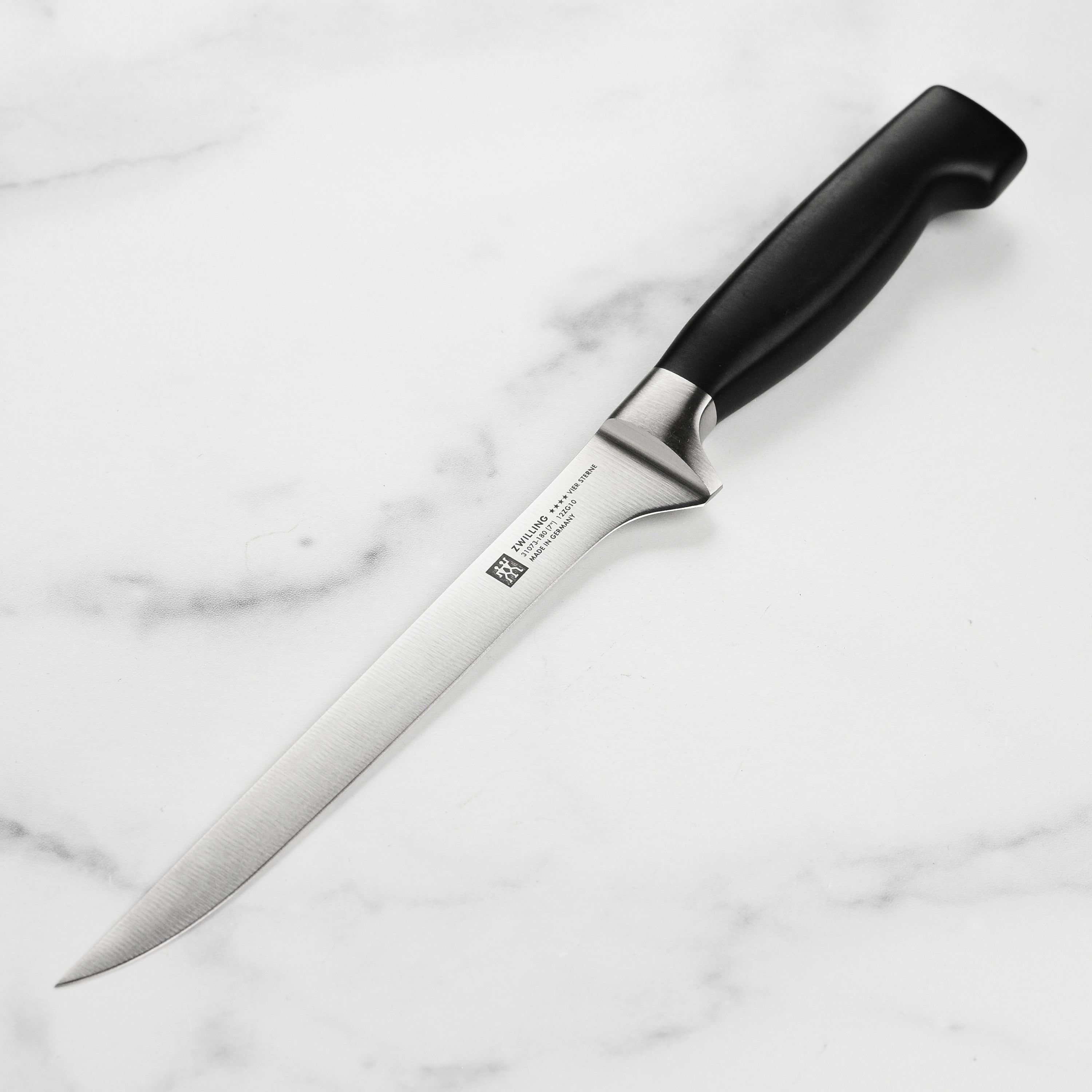 Close-up of the Zwilling Four Star fillet knife demonstrating its high carbon stainless steel blade.
