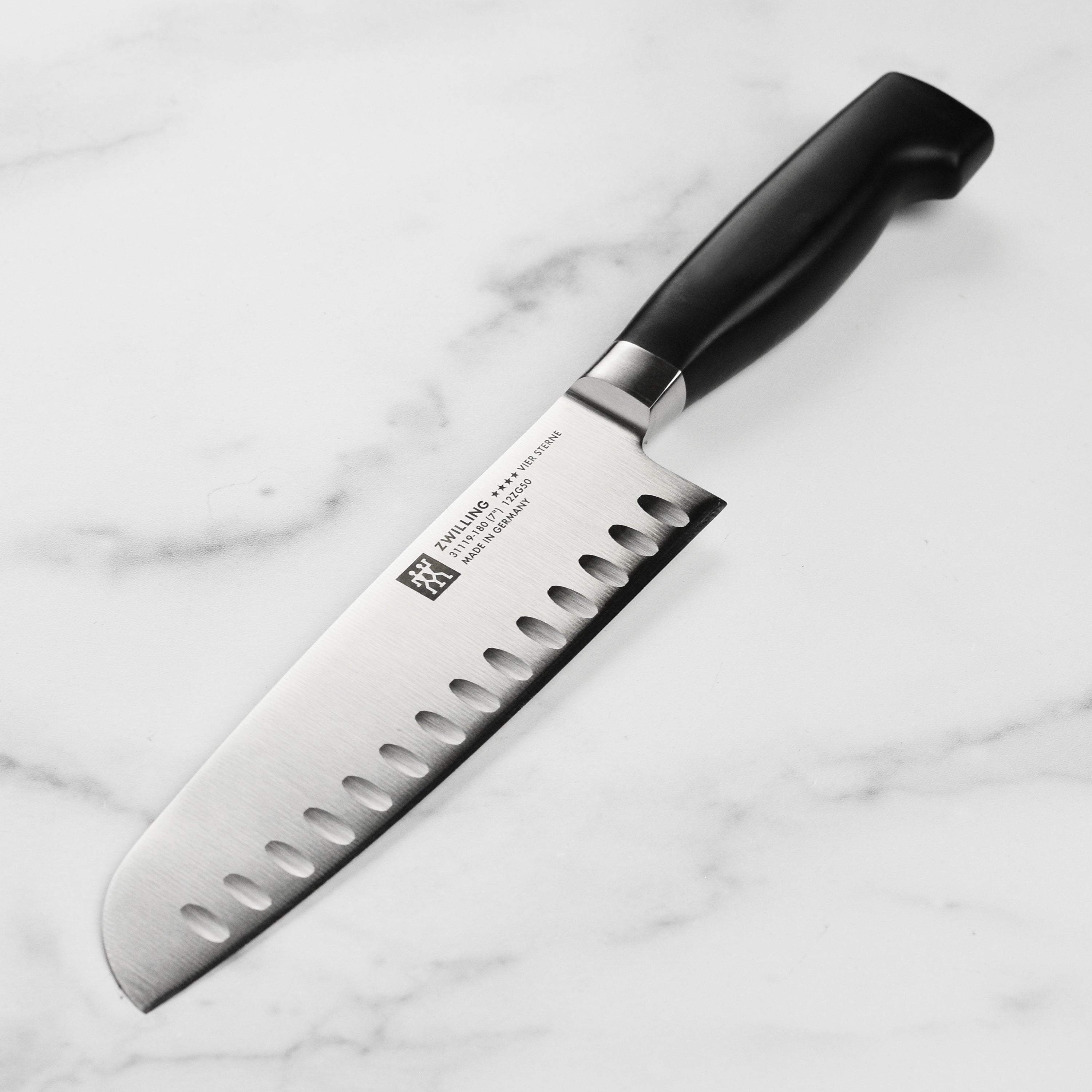 Zwilling Four Star 7-inch hollow edge santoku knife with sharp blade and ergonomic handle