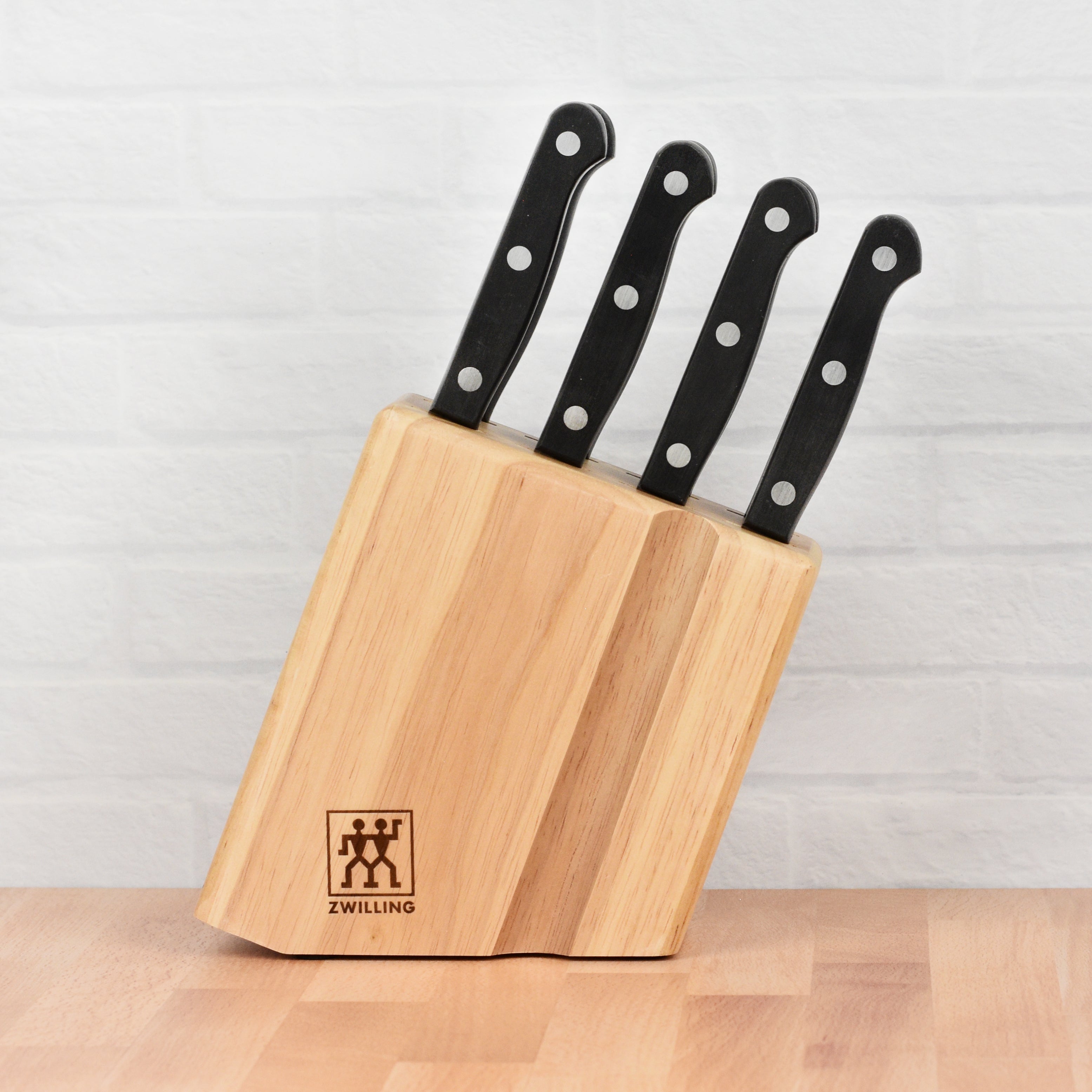 Premium Zwilling steak knives in a wooden block, showcasing their elegant design.