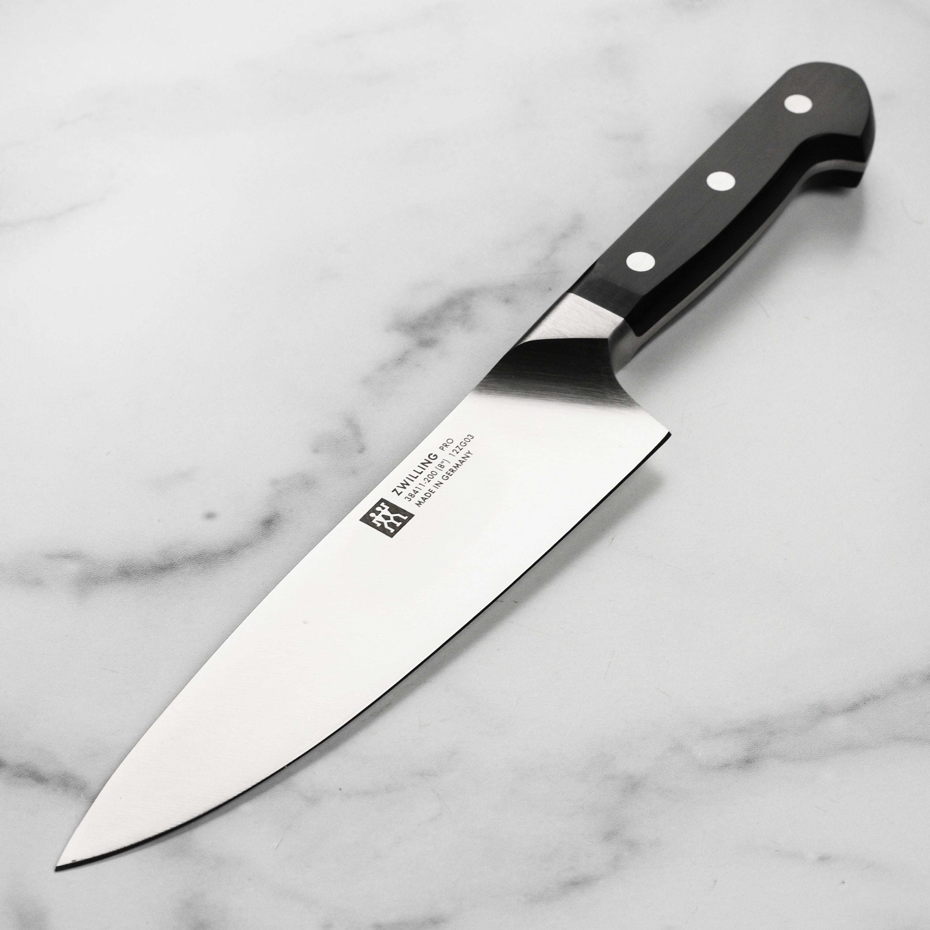 Zwilling Pro 8-Inch Chef's Knife from above, highlighting the curved bolster and blade edge.