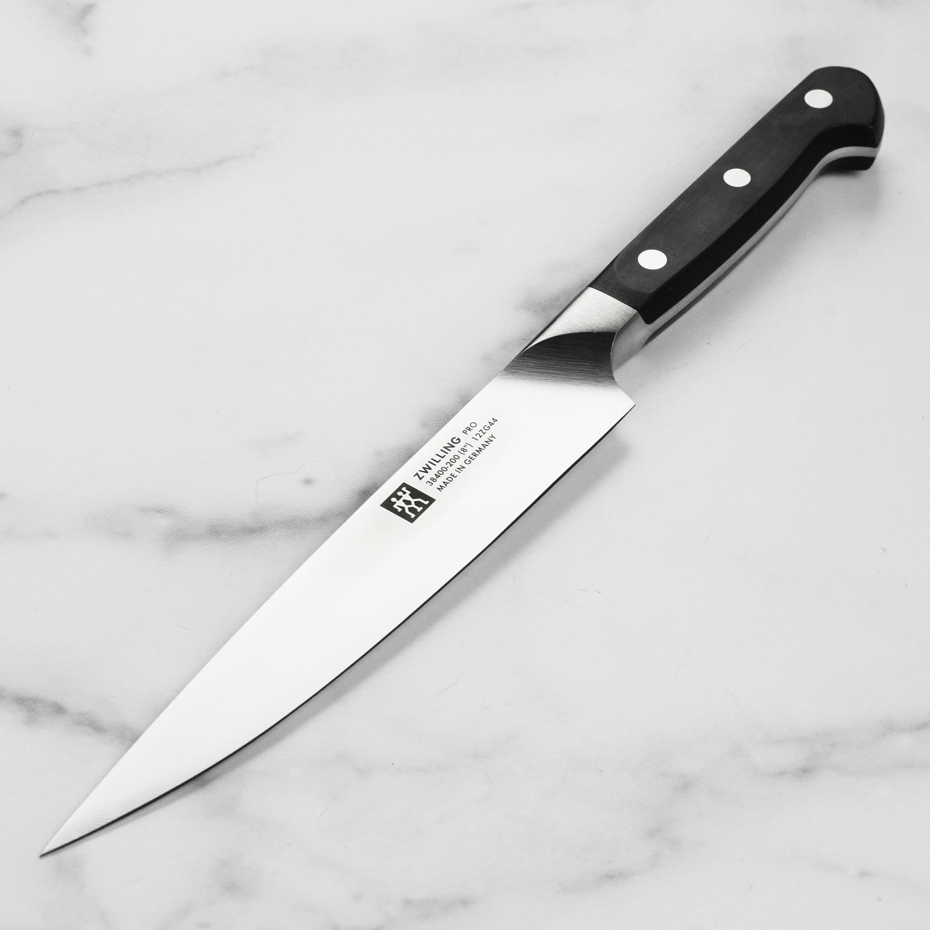 Close-up view of Zwilling Pro carving knife highlighting its sharp blade and ergonomic handle.