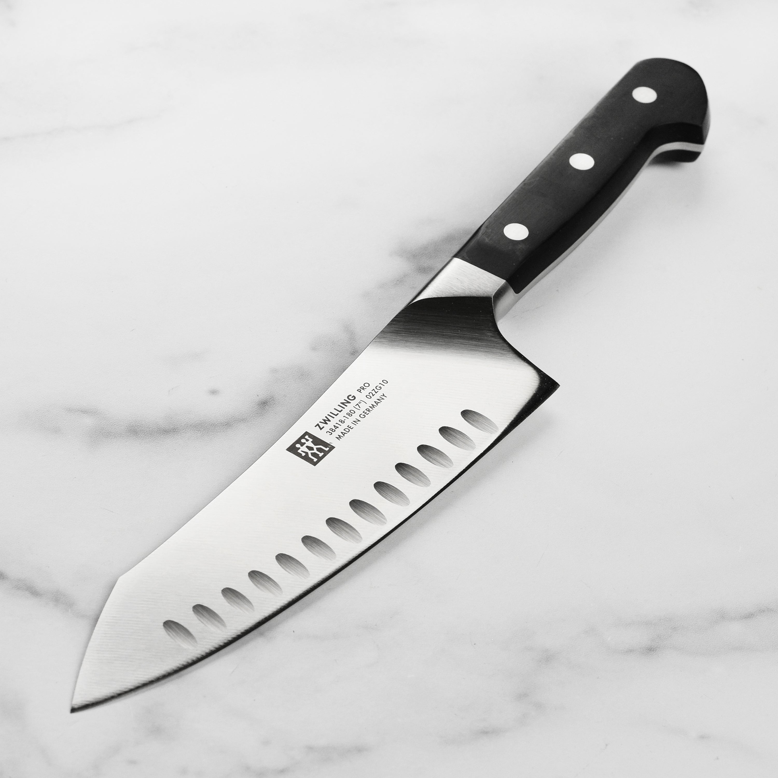 Front view of Zwilling Pro 7-inch Santoku knife with hollow edge for precise slicing