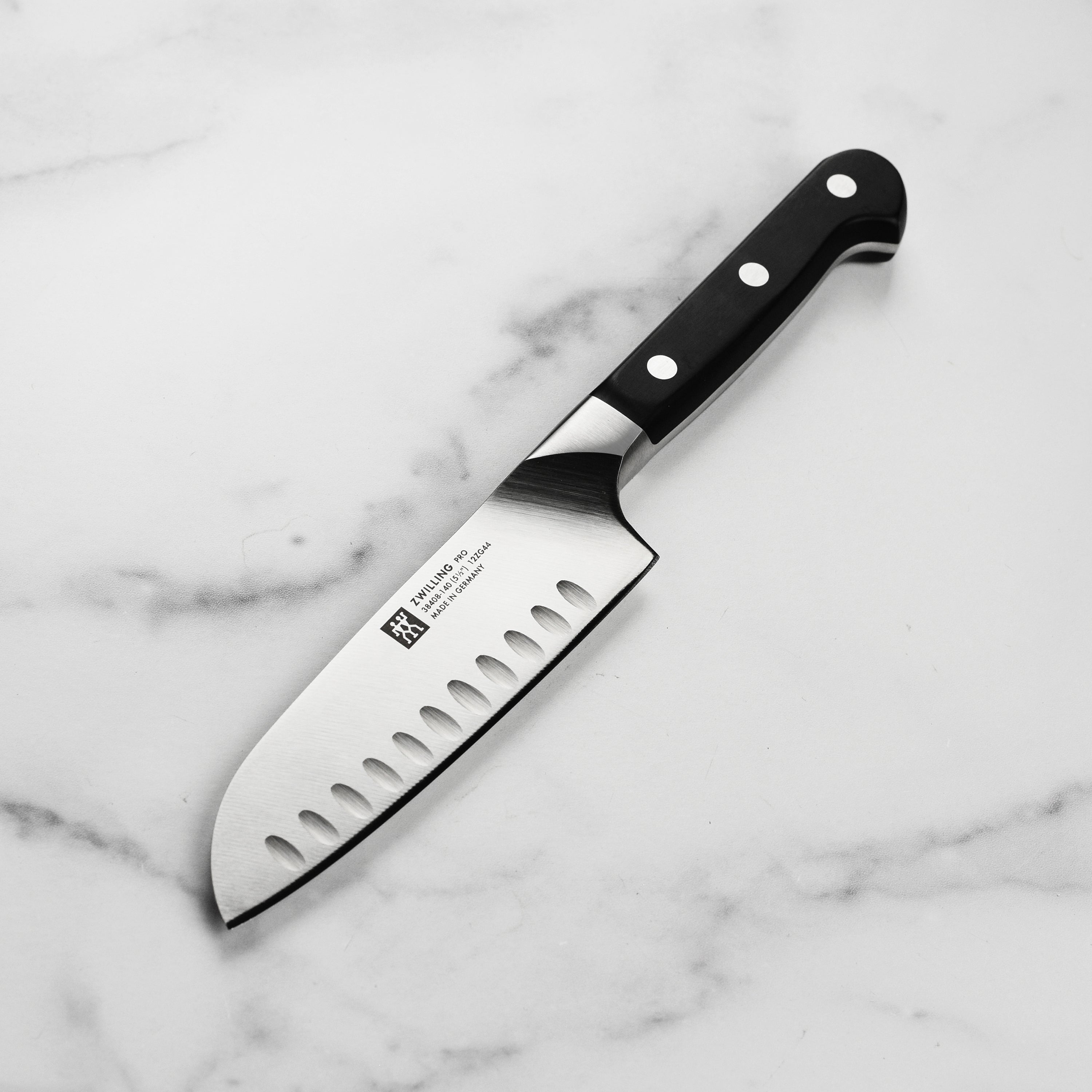 Close-up view of Zwilling Pro Santoku knife with hollow edge feature.