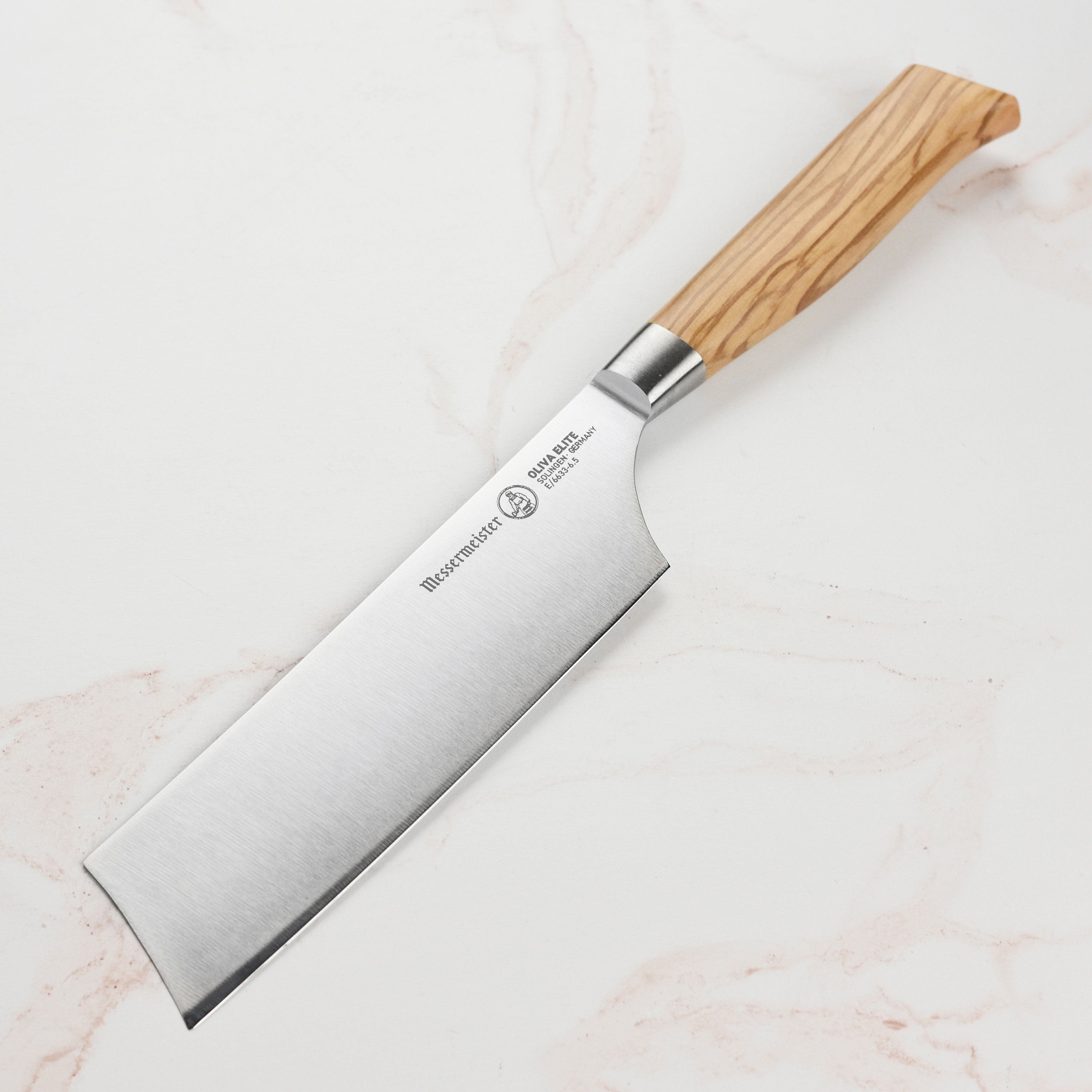 Close-up of the Messermeister Oliva Elite 6.5-inch Nakiri knife blade showing sharp edge and craftsmanship