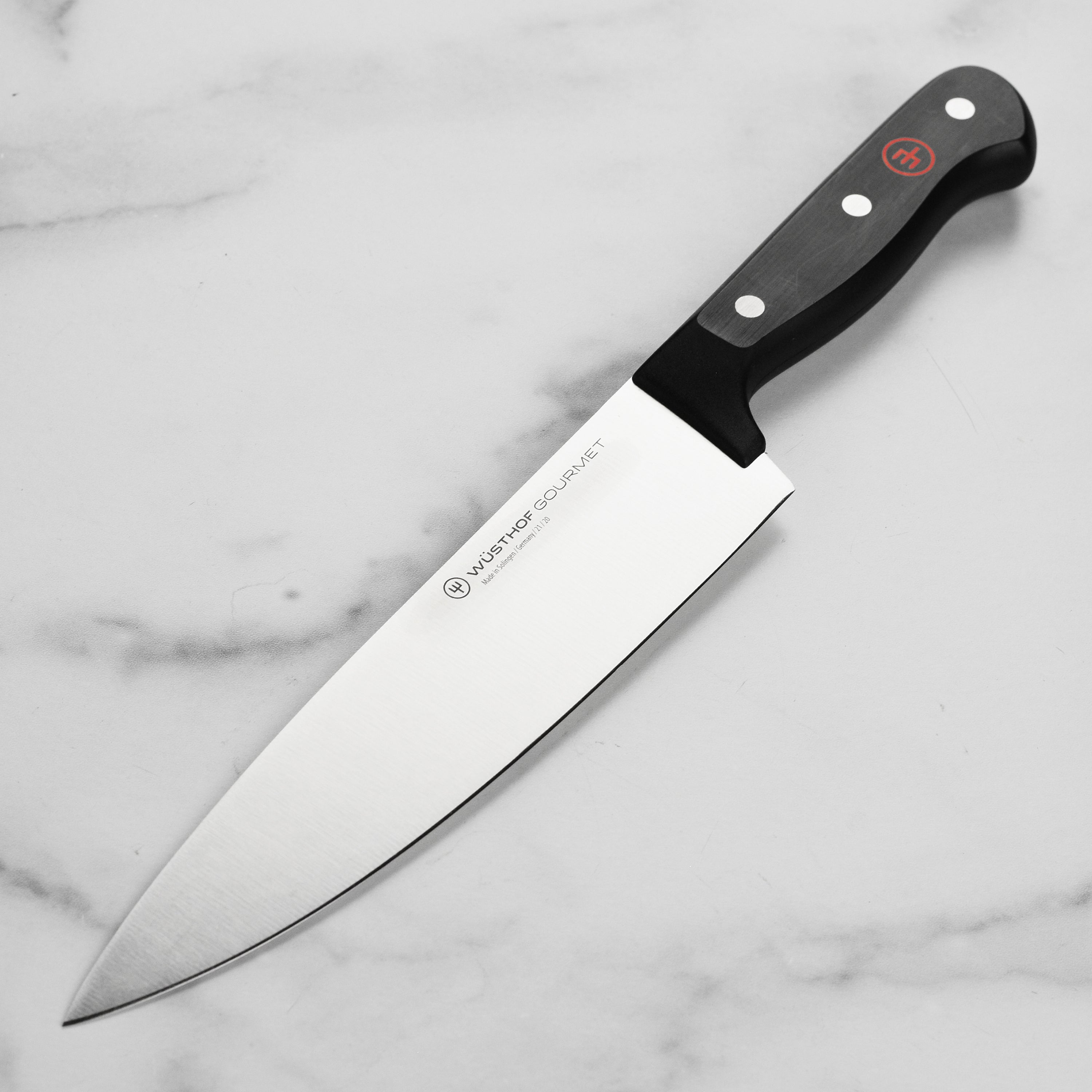 Wüsthof gourmet 8-inch chef's knife blade close-up, showcasing sharpness and craftsmanship