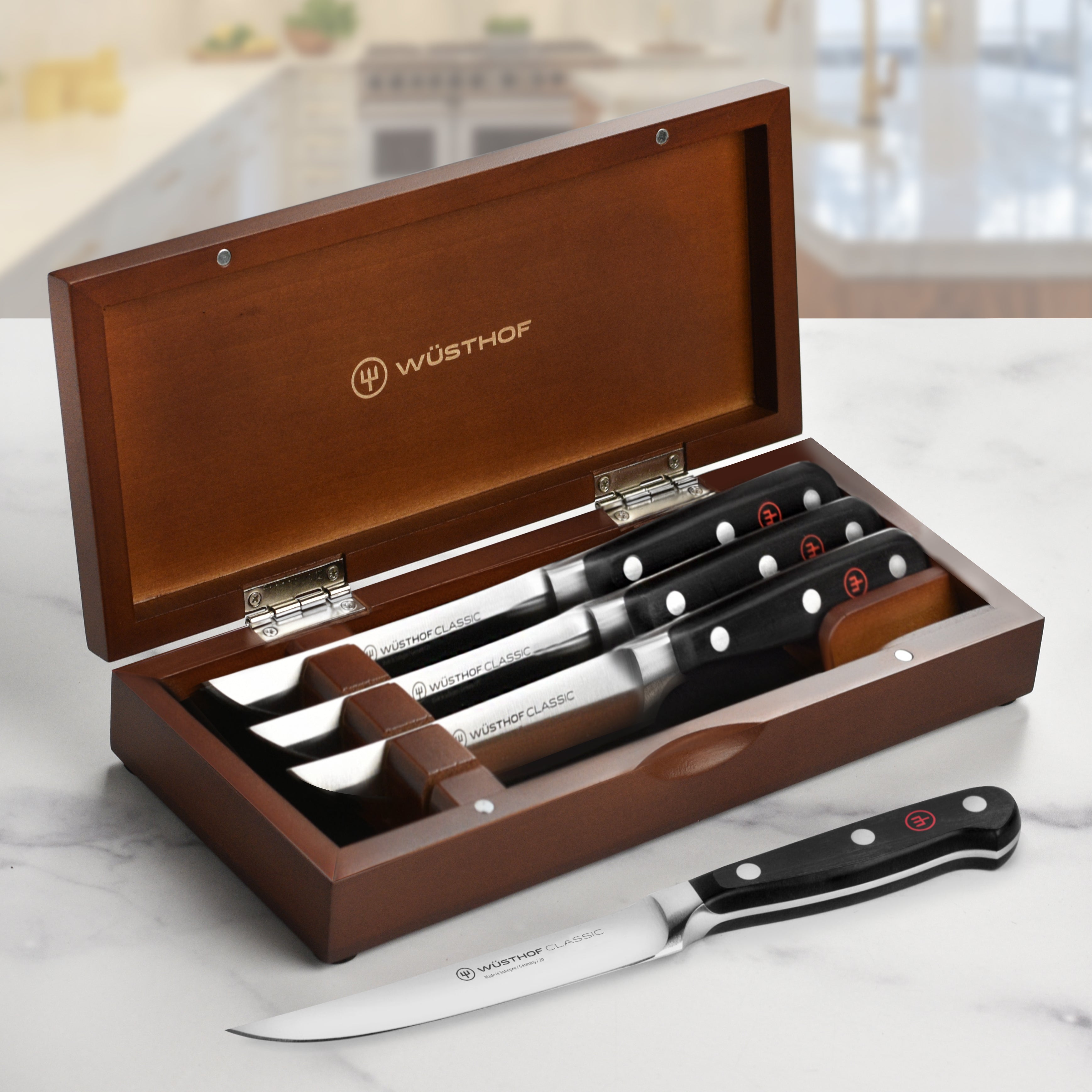 Close-up of Wusthof Classic steak knives in wood case, showing full tang and triple-riveted handles