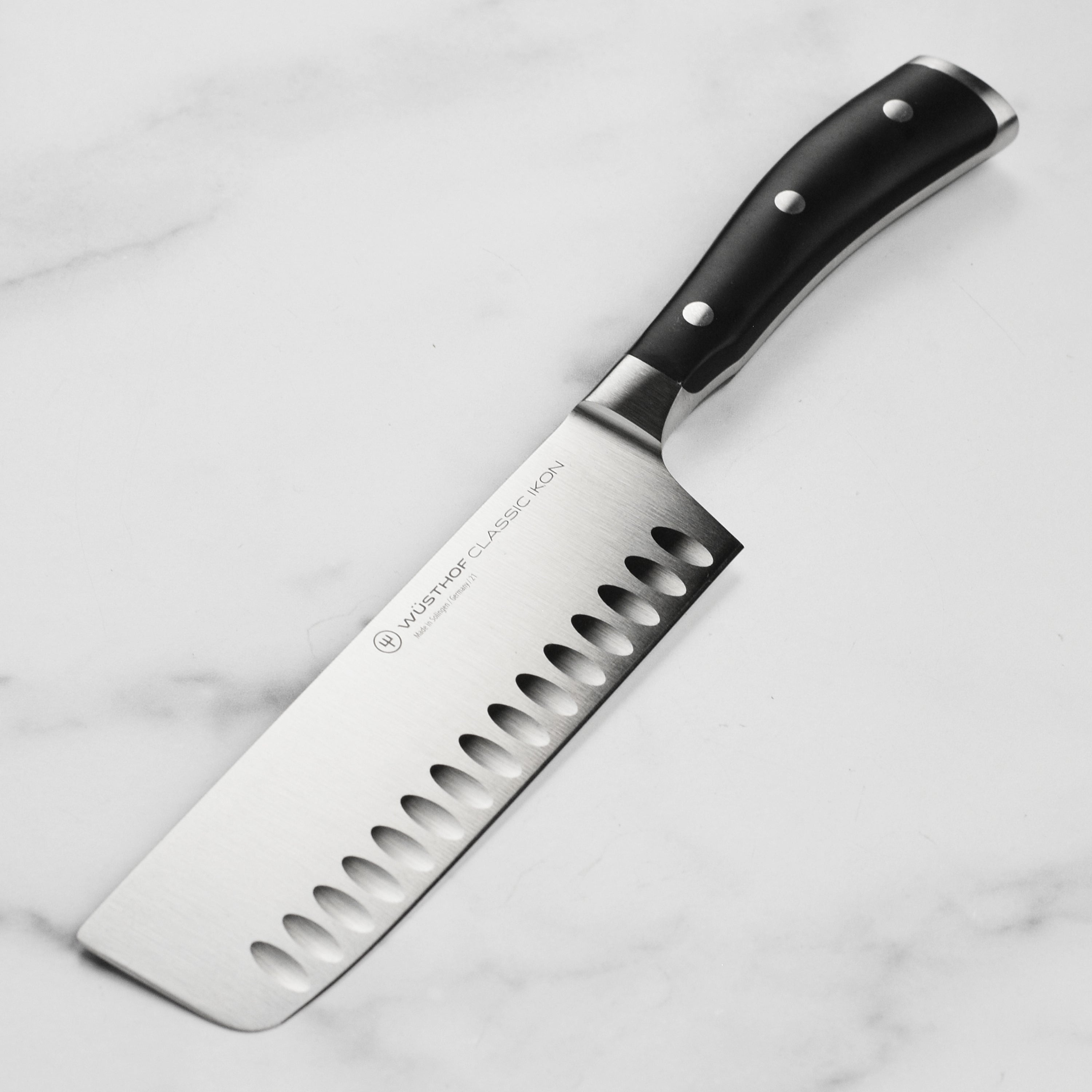 Wusthof Classic Ikon Nakiri Knife angled view, highlighting the sharp blade and ergonomic handle.