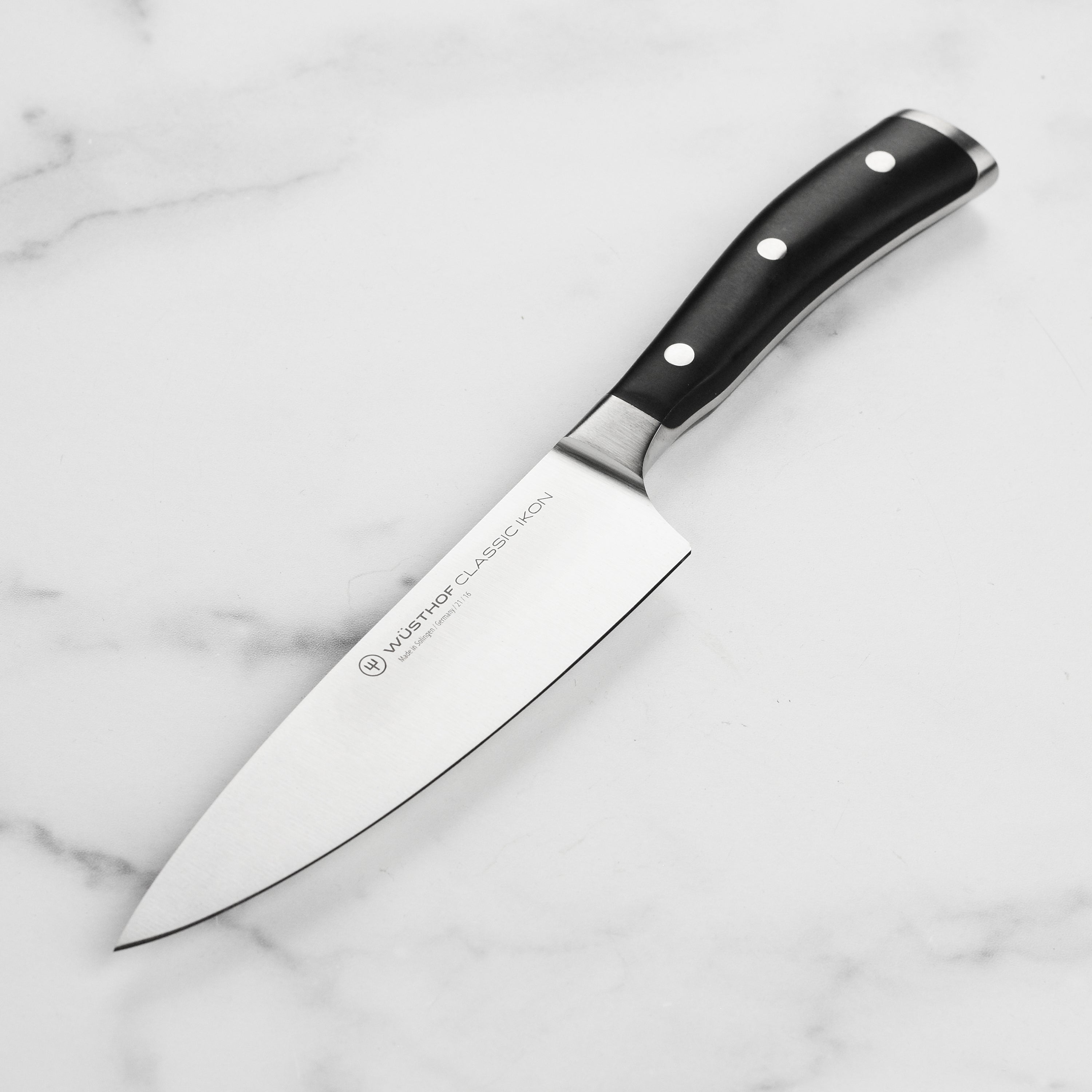 Wusthof Classic Ikon 6-inch chef's knife with sharp blade and black handle for precision cutting