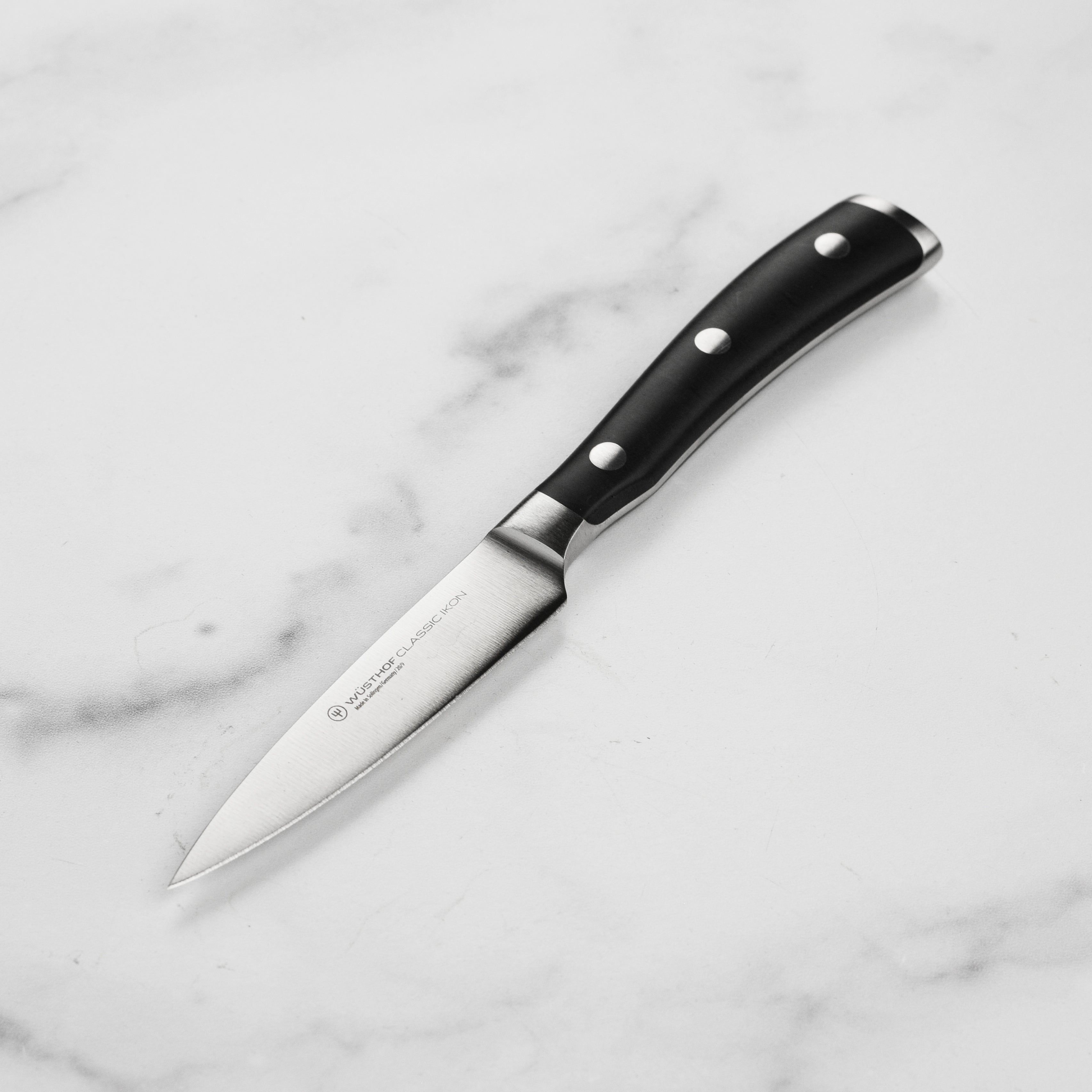 Close-up of the Wusthof Classic Ikon paring knife blade displaying its sharp edge and high-carbon stainless steel finish.