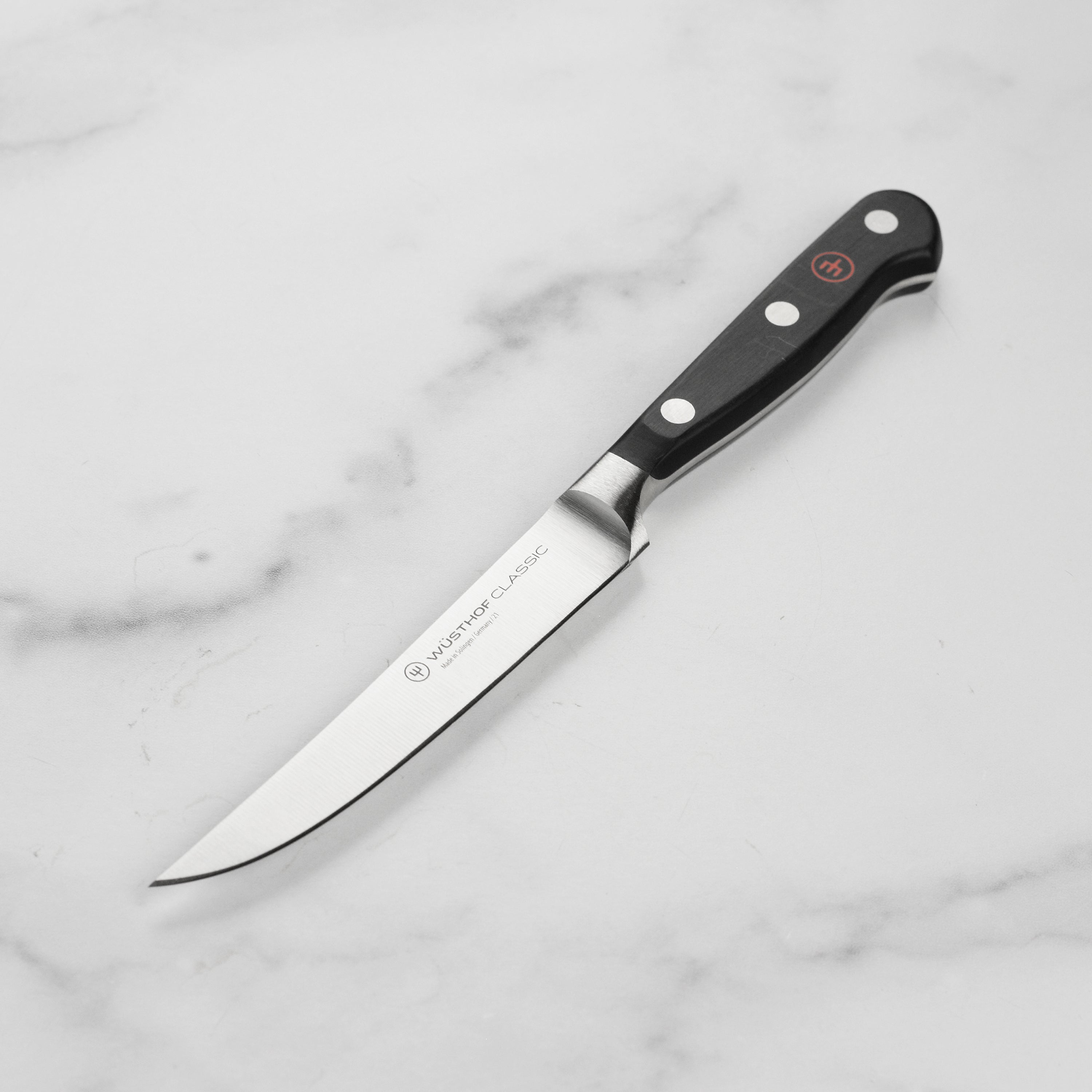 Close-up of the Wusthof Classic 4.5-Inch Premium Steak Knife highlighting its sharp edge and craftsmanship.