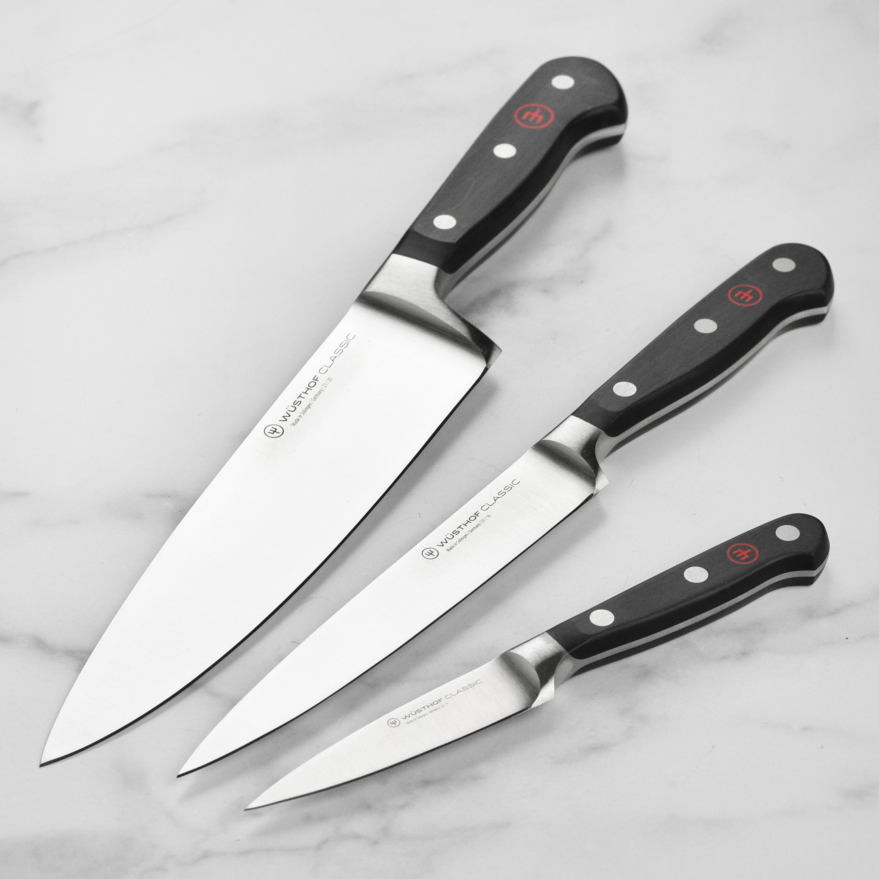 Top view of Wusthof knife set showing full tang construction and polished stainless steel blades