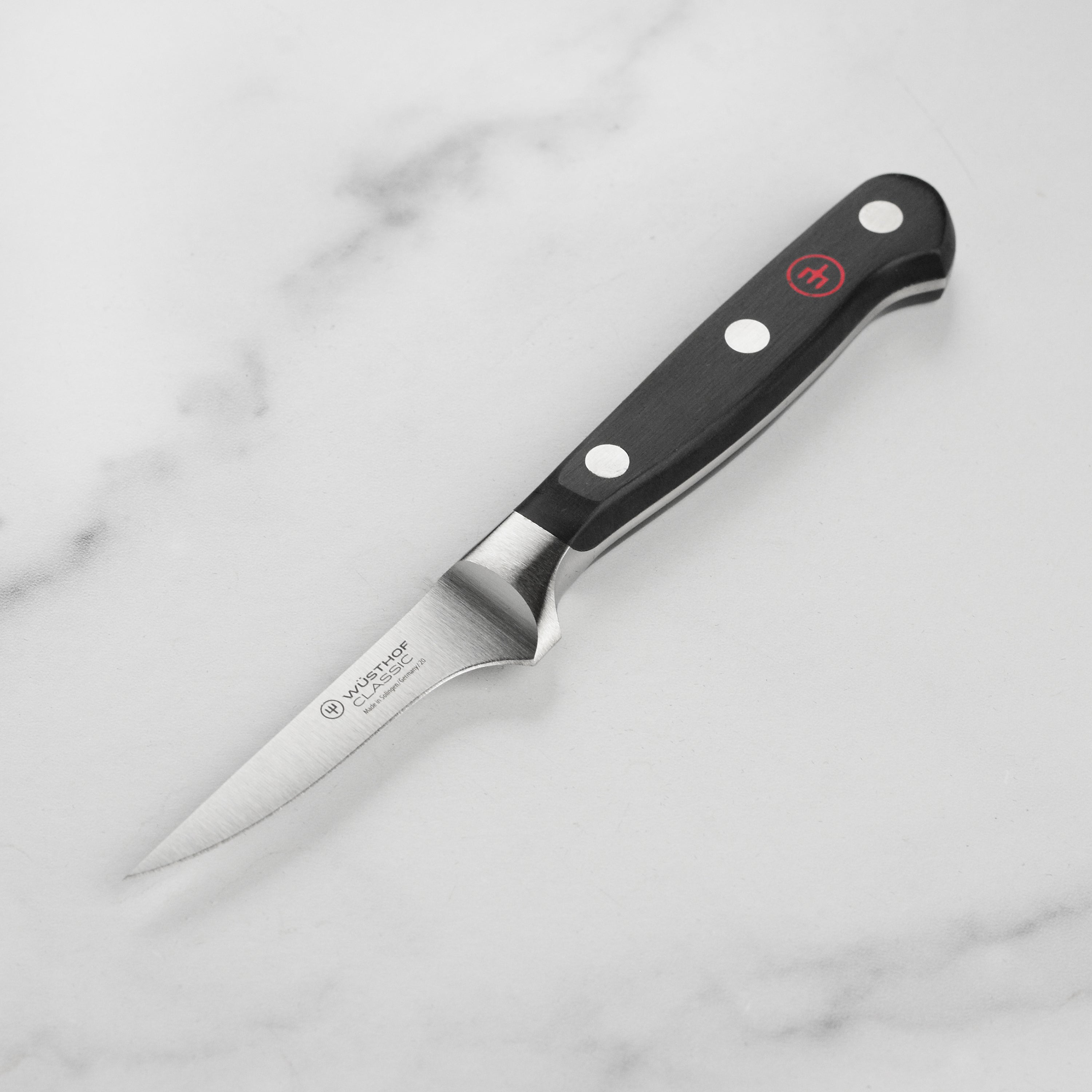 Wusthof Precision Trimming Knife with a sharp edge and ergonomic handle, ideal for chefs.