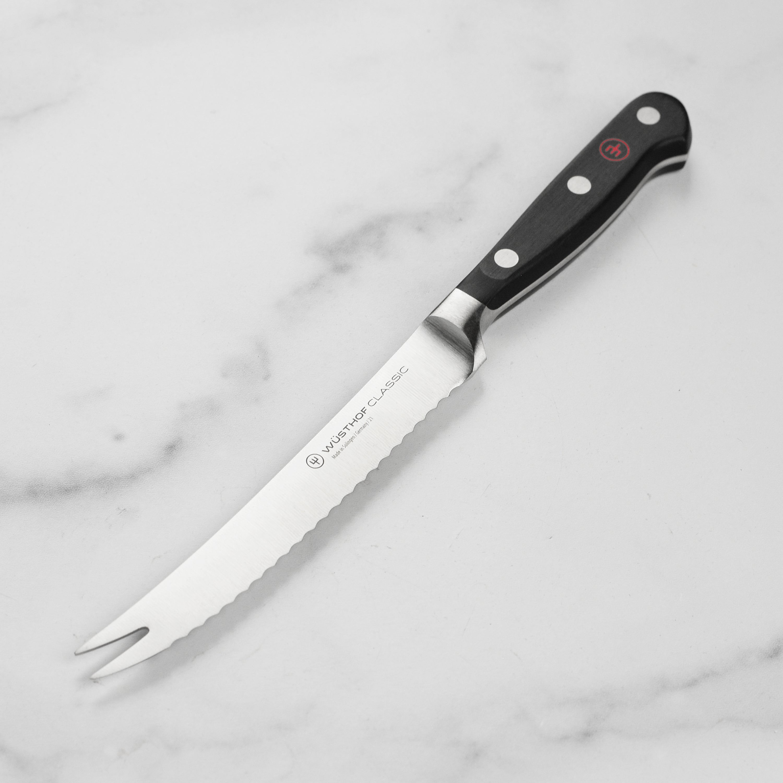 Wusthof Classic 5-inch tomato knife showcasing its sharp blade and ergonomic handle