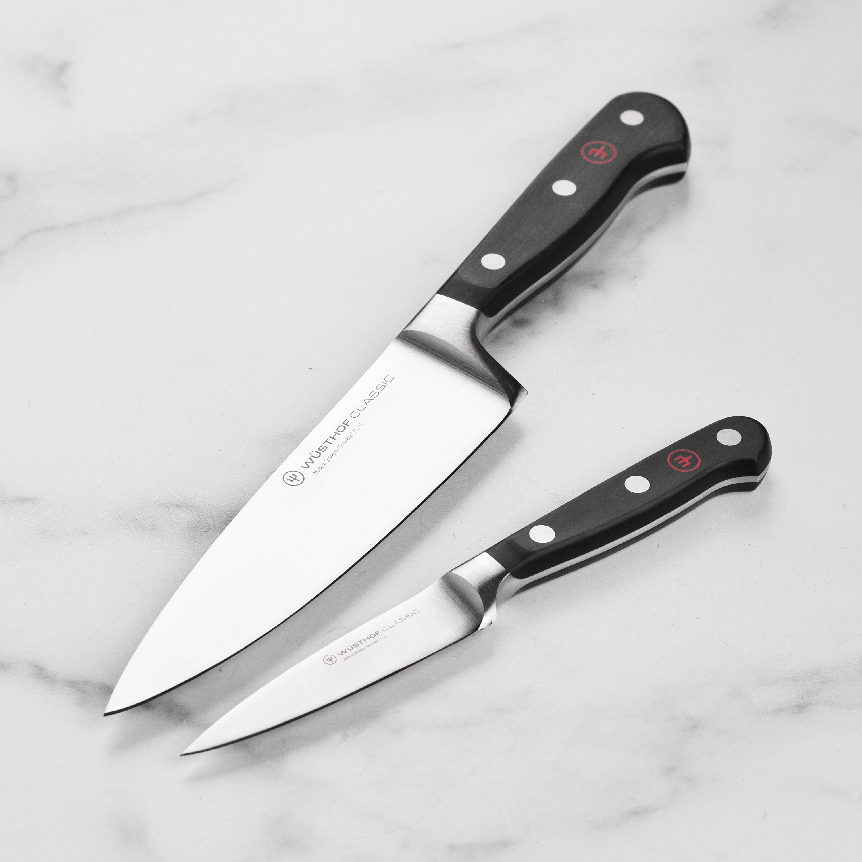 Wusthof Classic Essential Knife Set on a wooden kitchen counter, highlighting the sharp blades and ergonomic handles.