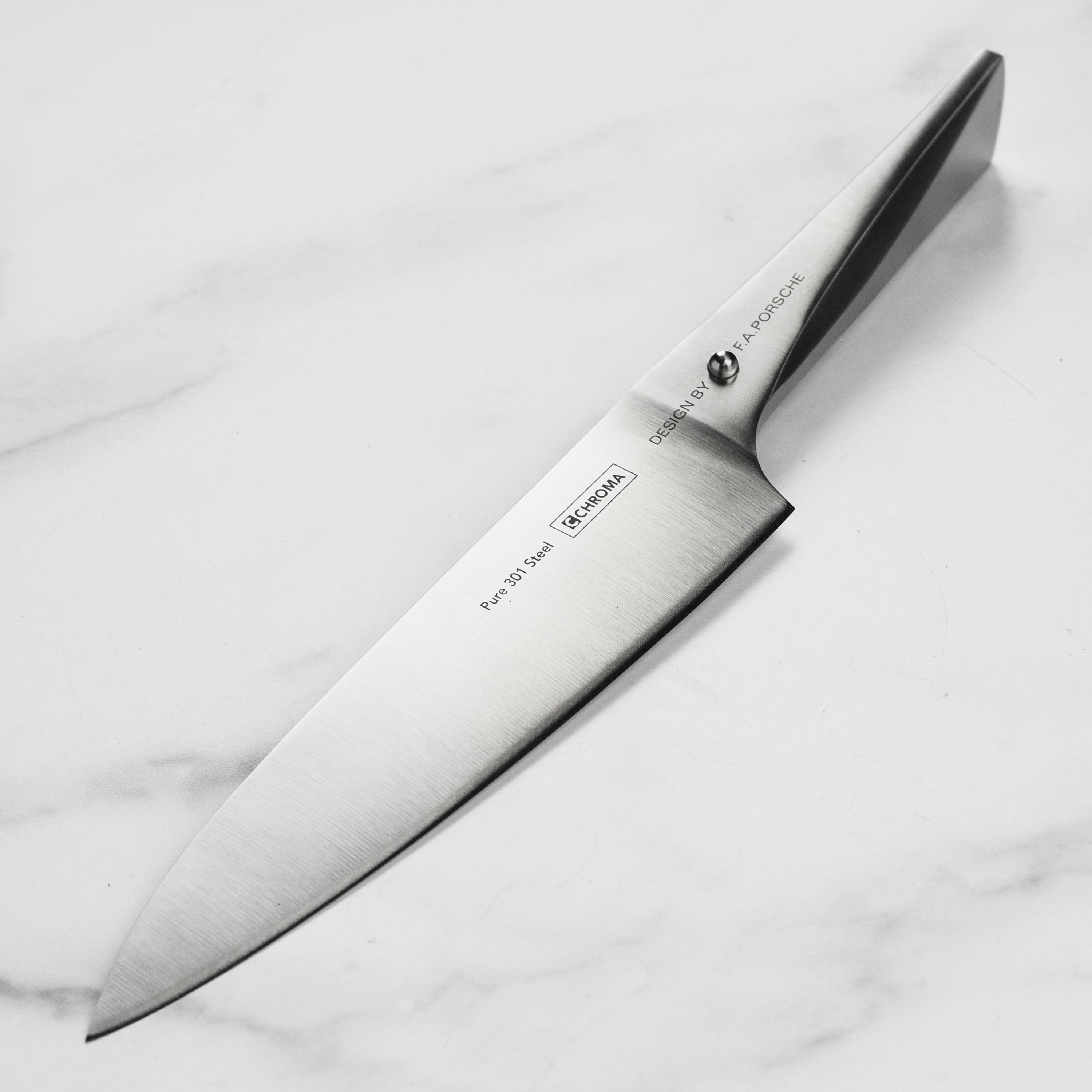 Chroma Type 301 chef knife angled view highlighting the ergonomic handle and sharp blade.