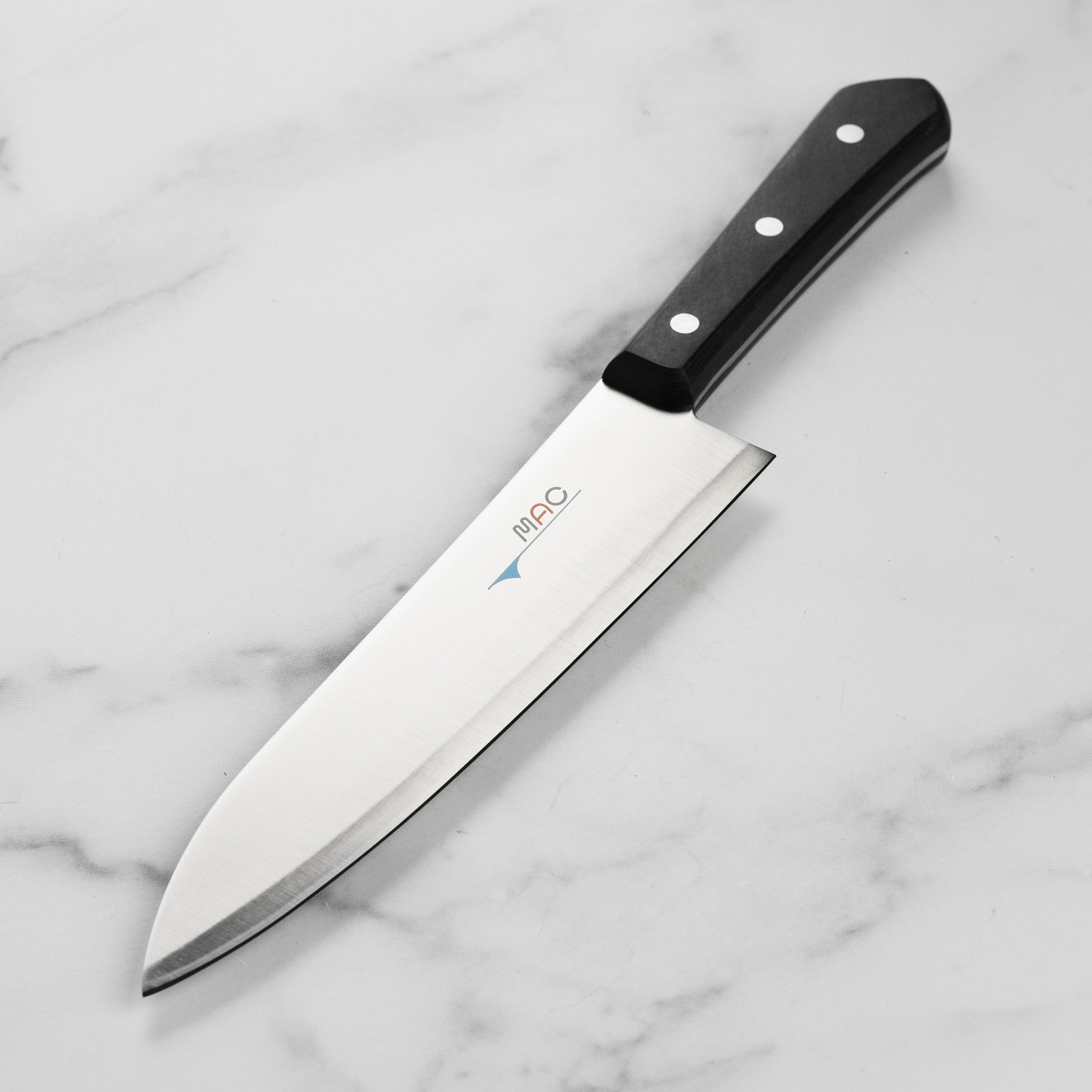 Close-up view of the MAC Chef Series 8-Inch chef knife highlighting the sharp blade and Pakkawood handle.