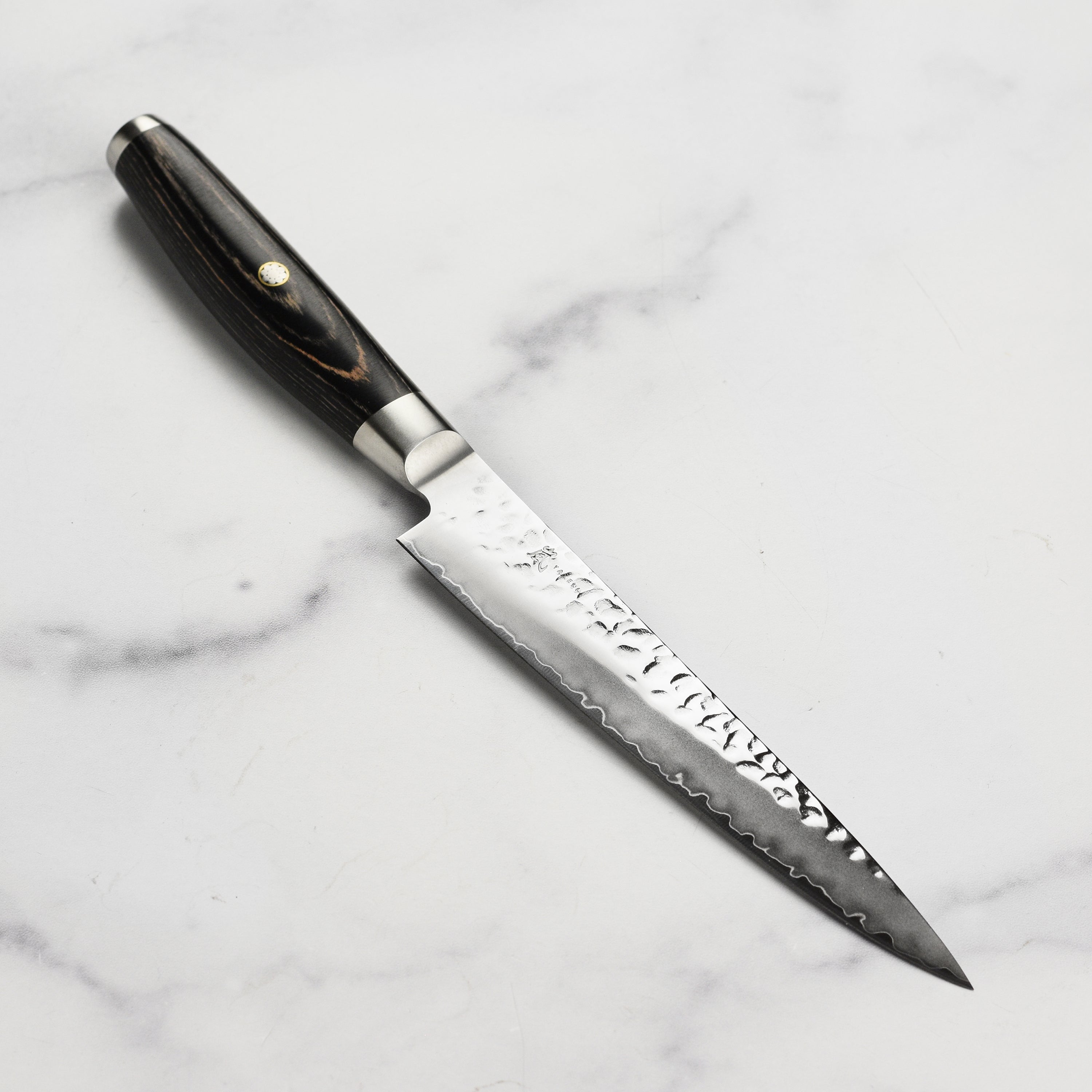 Yaxell Ketu SG2 utility knife with a hammered finish and Katana wave pattern, ideal for chefs looking for precision and style.