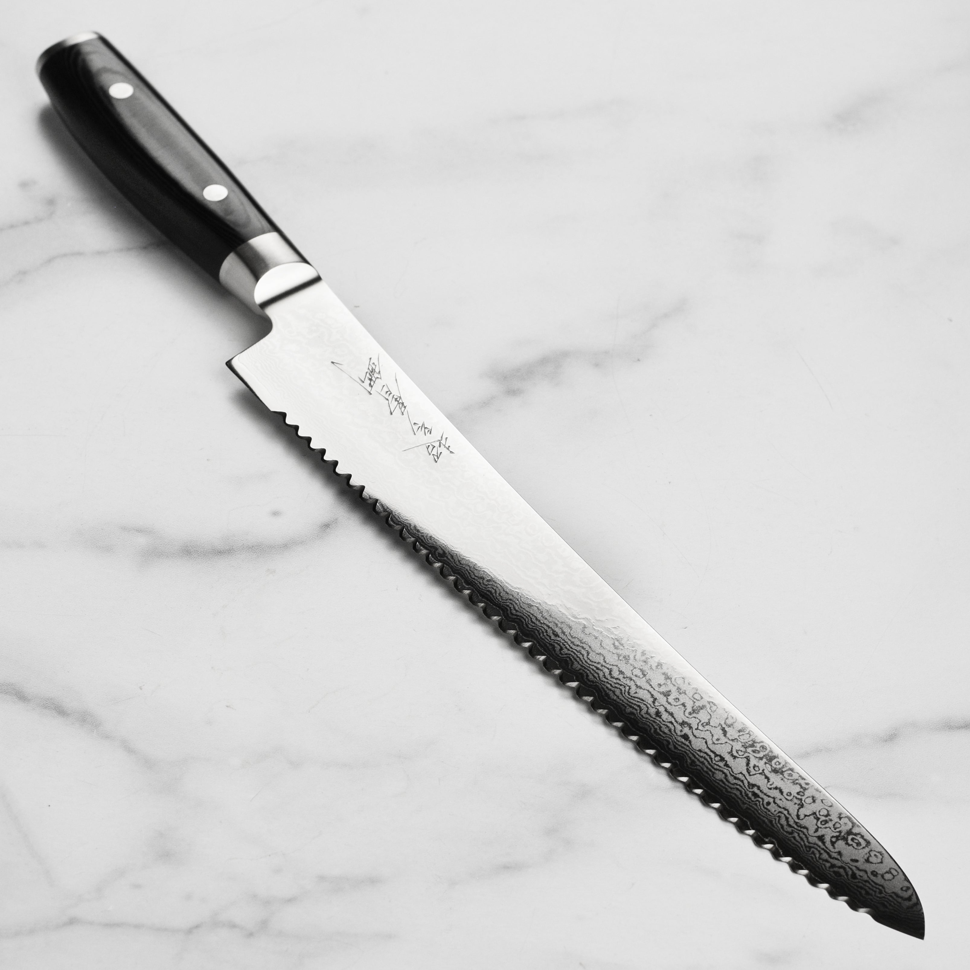 Yaxell Ran Plus Damascus knife blade detail highlighting layers and craftsmanship