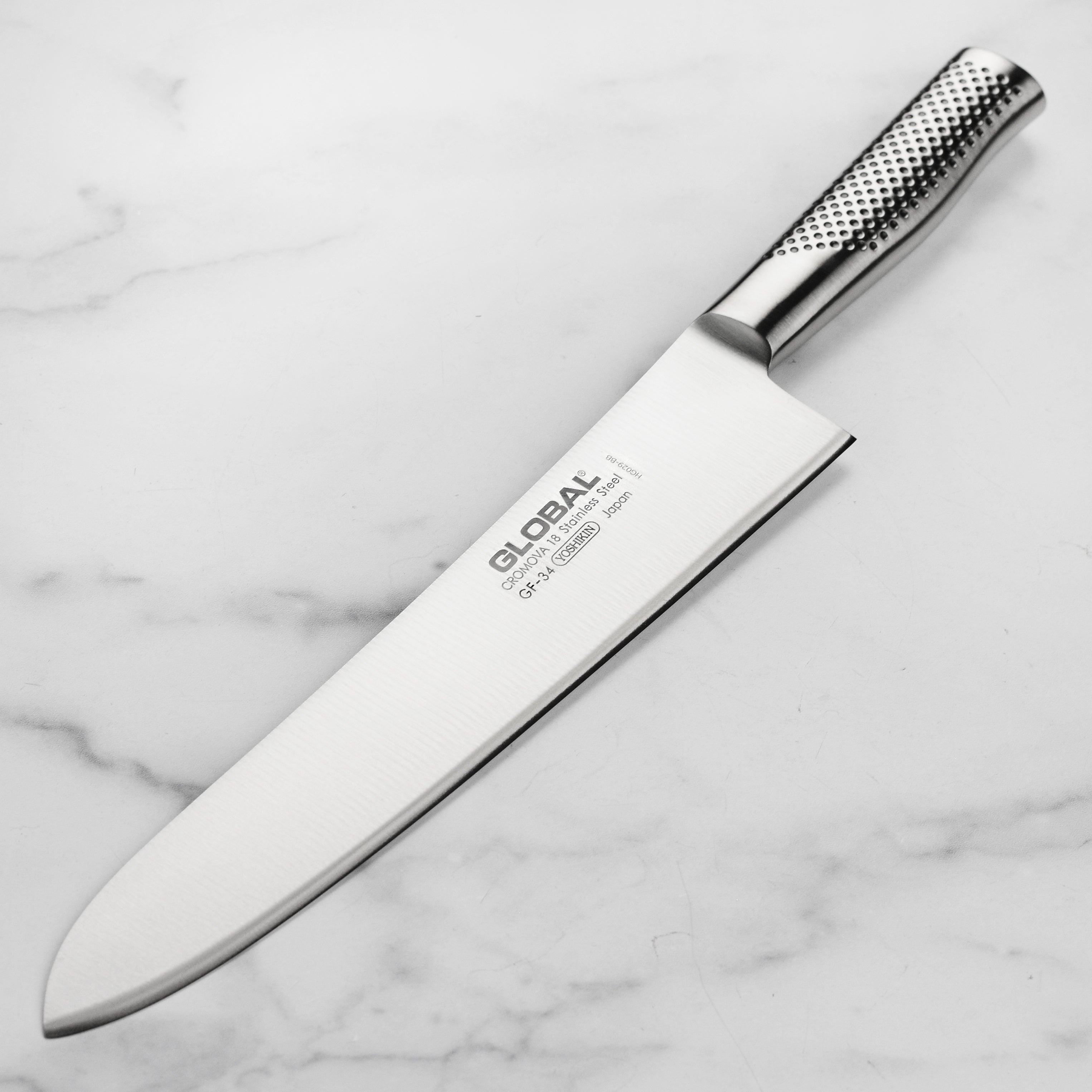Global 10.5-inch heavyweight chef's knife with sharp blade and ergonomic handle