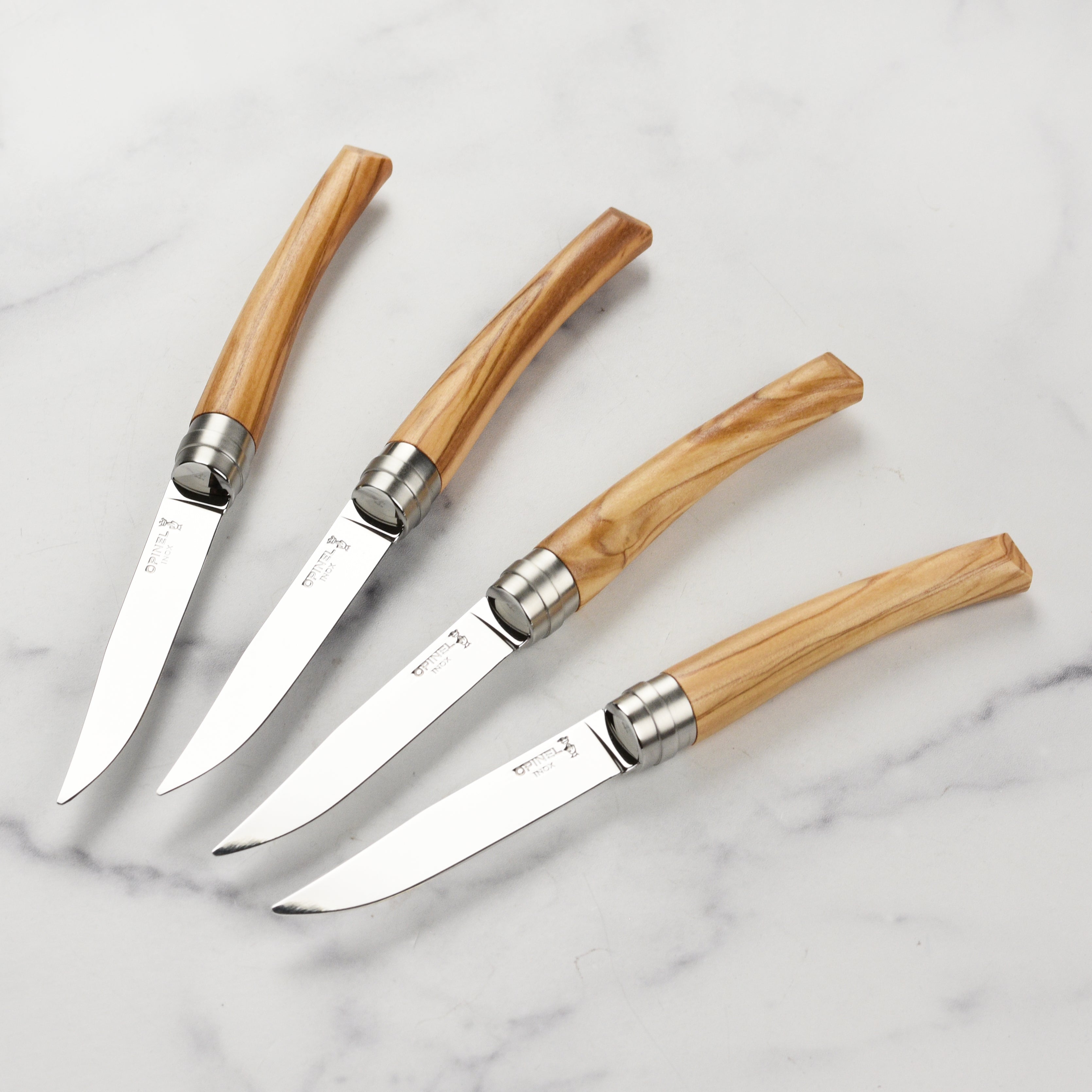 Close-up of the olivewood steak knife set showcasing the sleek design and sharp blades.