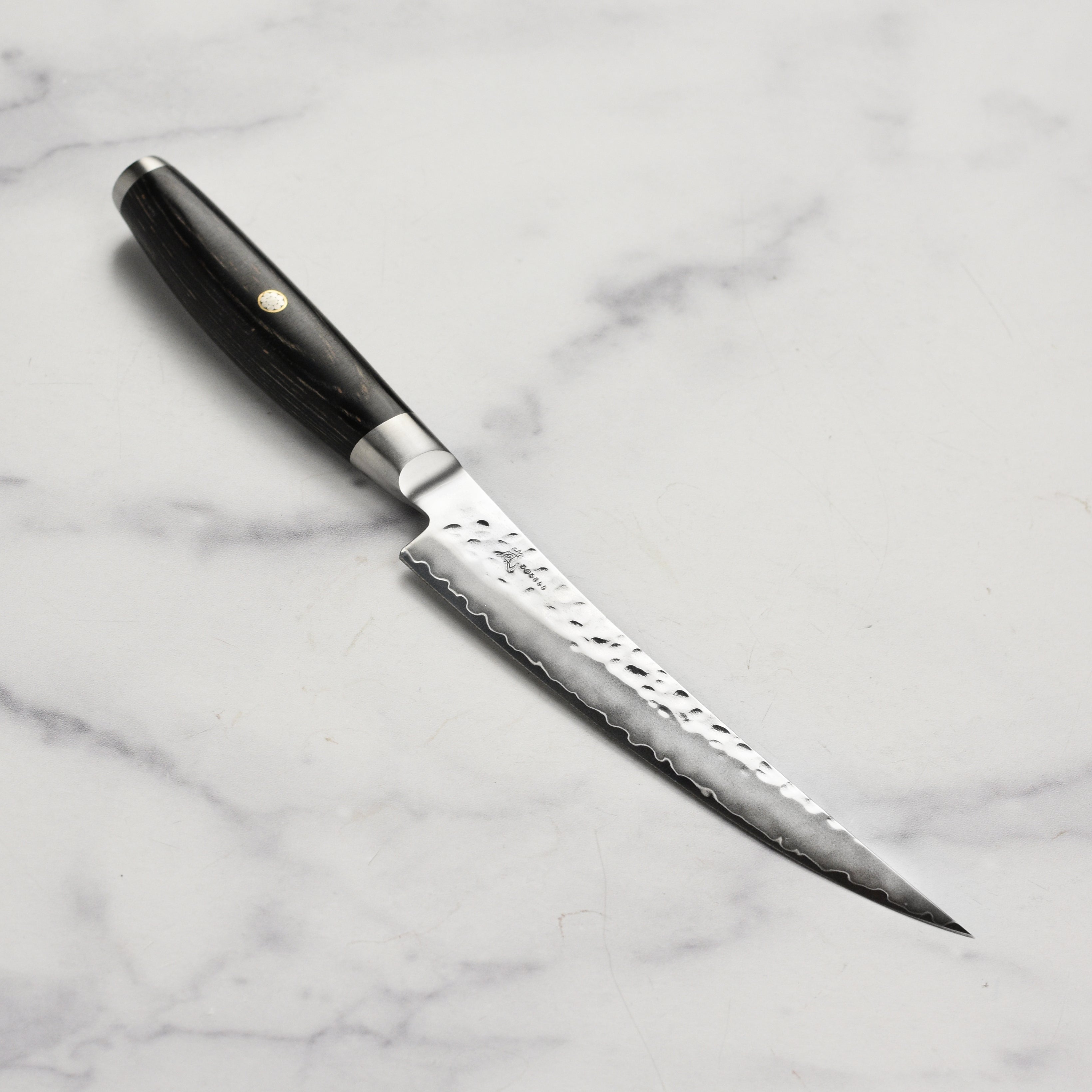 Yaxell Ketu SG2 boning knife with hammered blade and black pakkawood handle for precision butchery