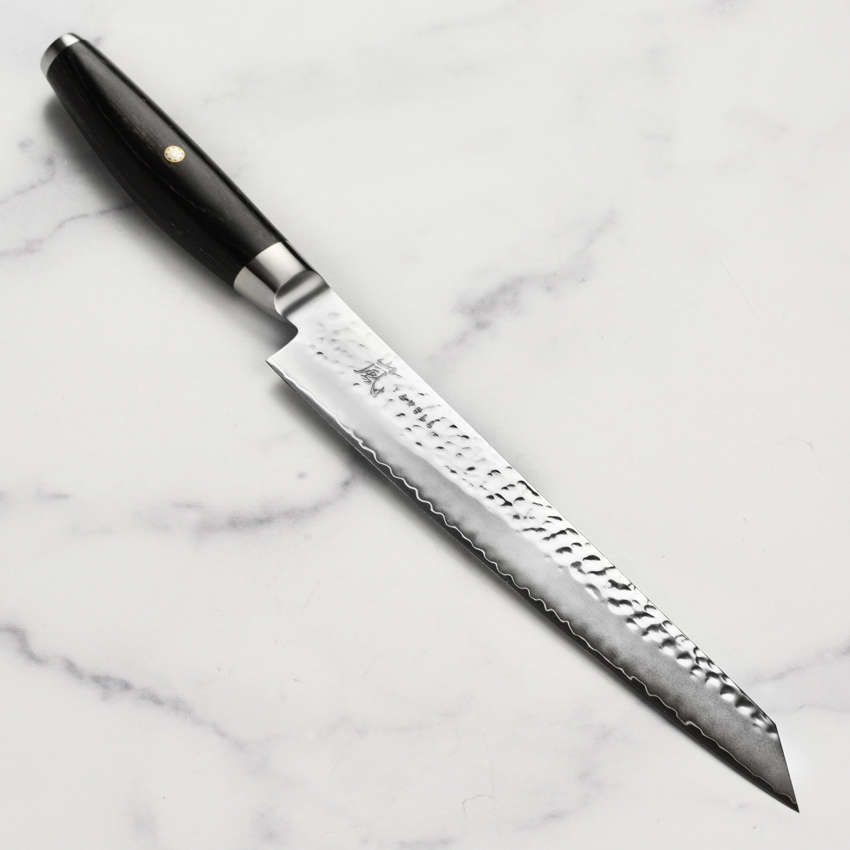 Yaxell Ketu slicing knife with a detailed view of the hammered blade finish.