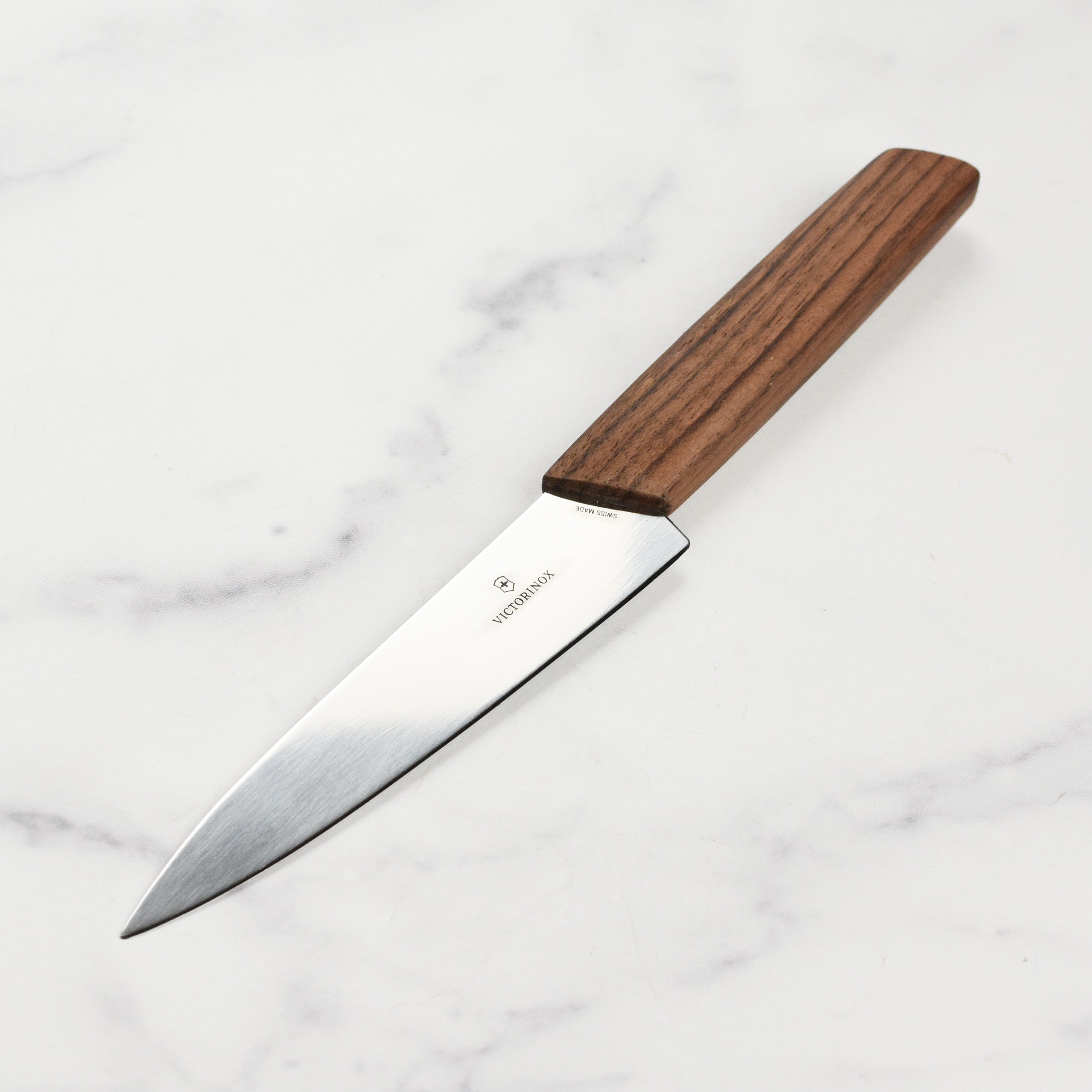 Side view of Victorinox Swiss Modern Utility Knife highlighting the high-carbon steel blade and Italian Walnut handle.