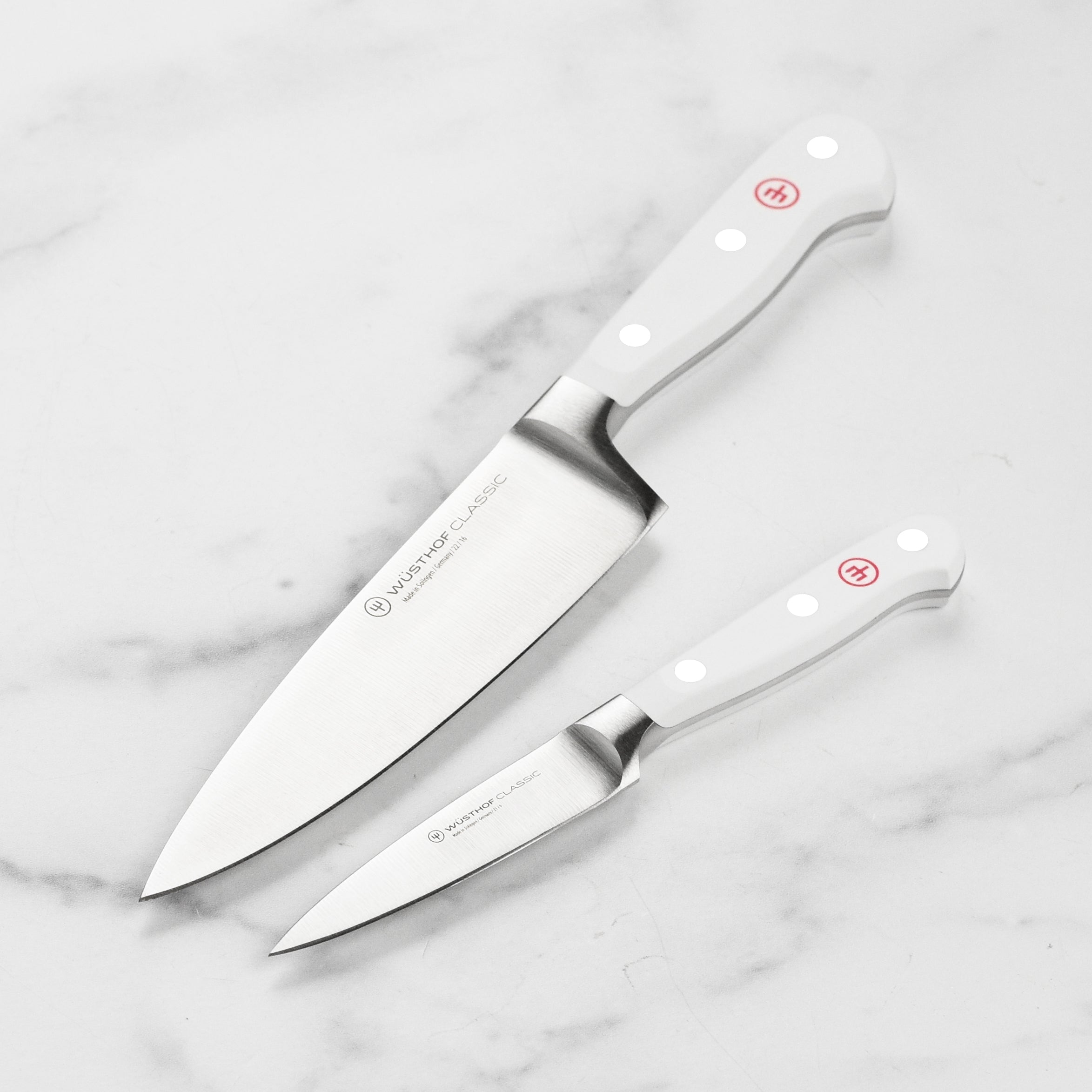 Wusthof Classic prep knife set displayed on a wooden cutting board, highlighting the sharp blades.